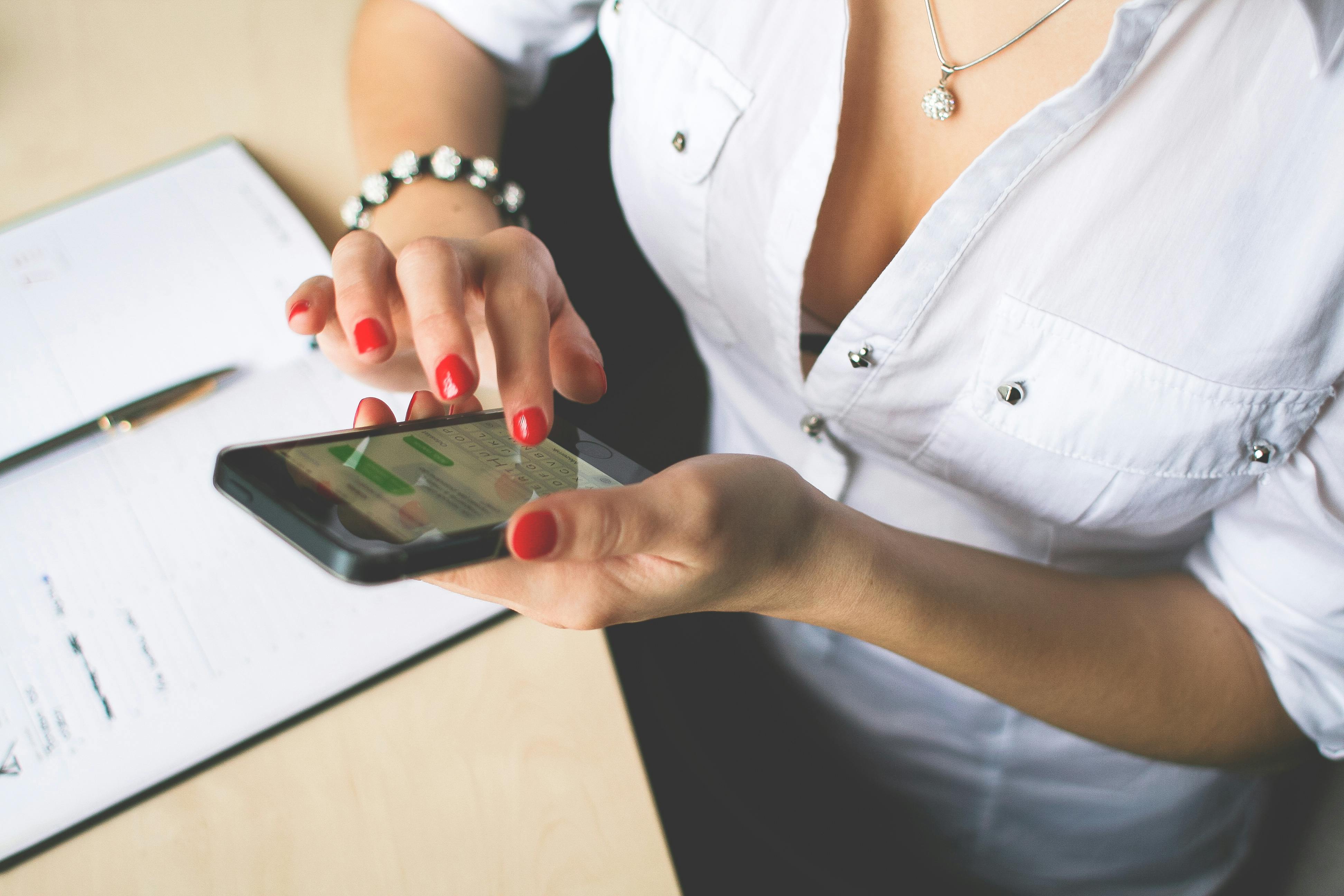 A woman checking a message on her phone | Source: Pexels