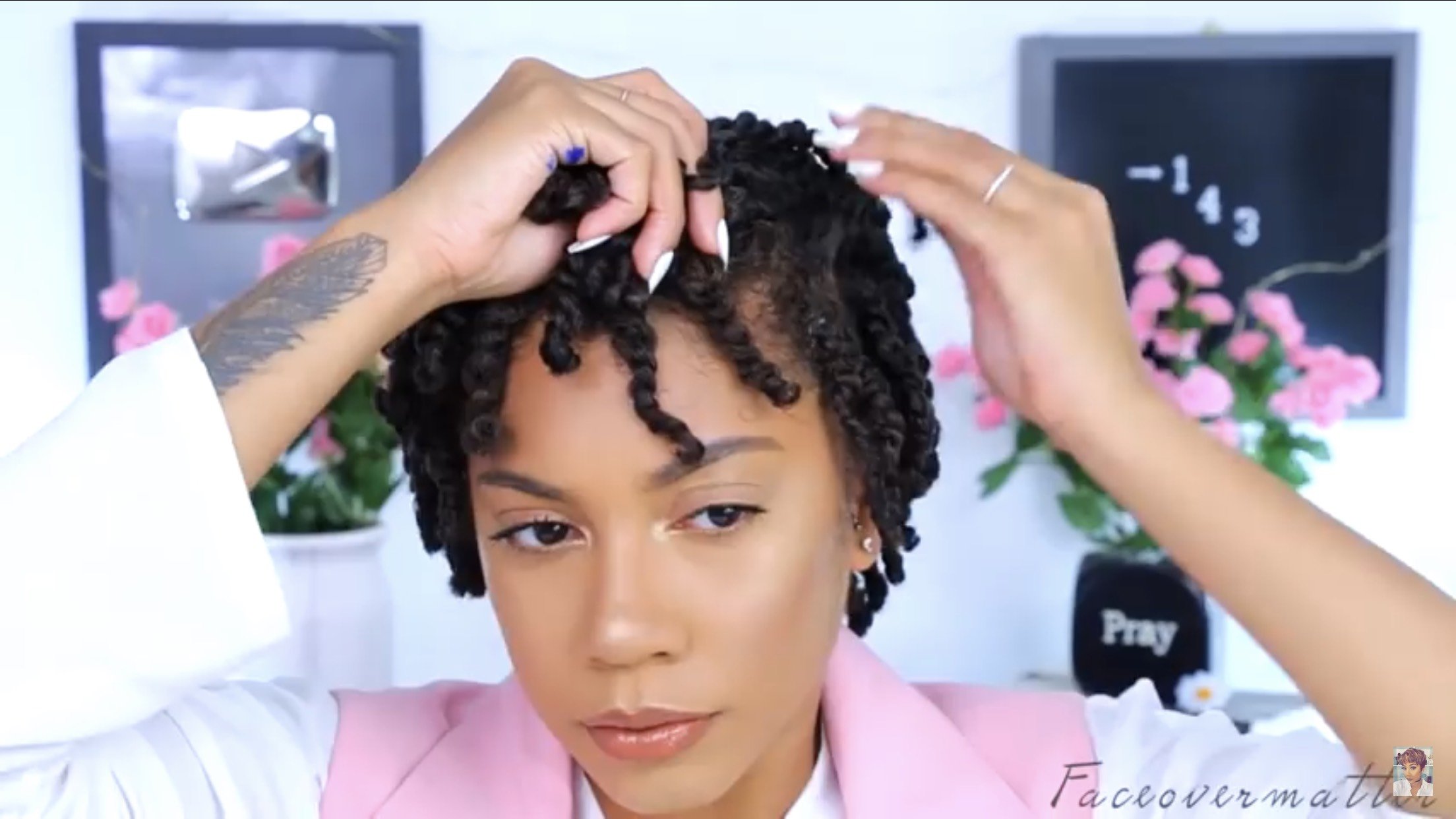 A photo of a woman with two-strand twists | Source: YouTube/ faceovermatter