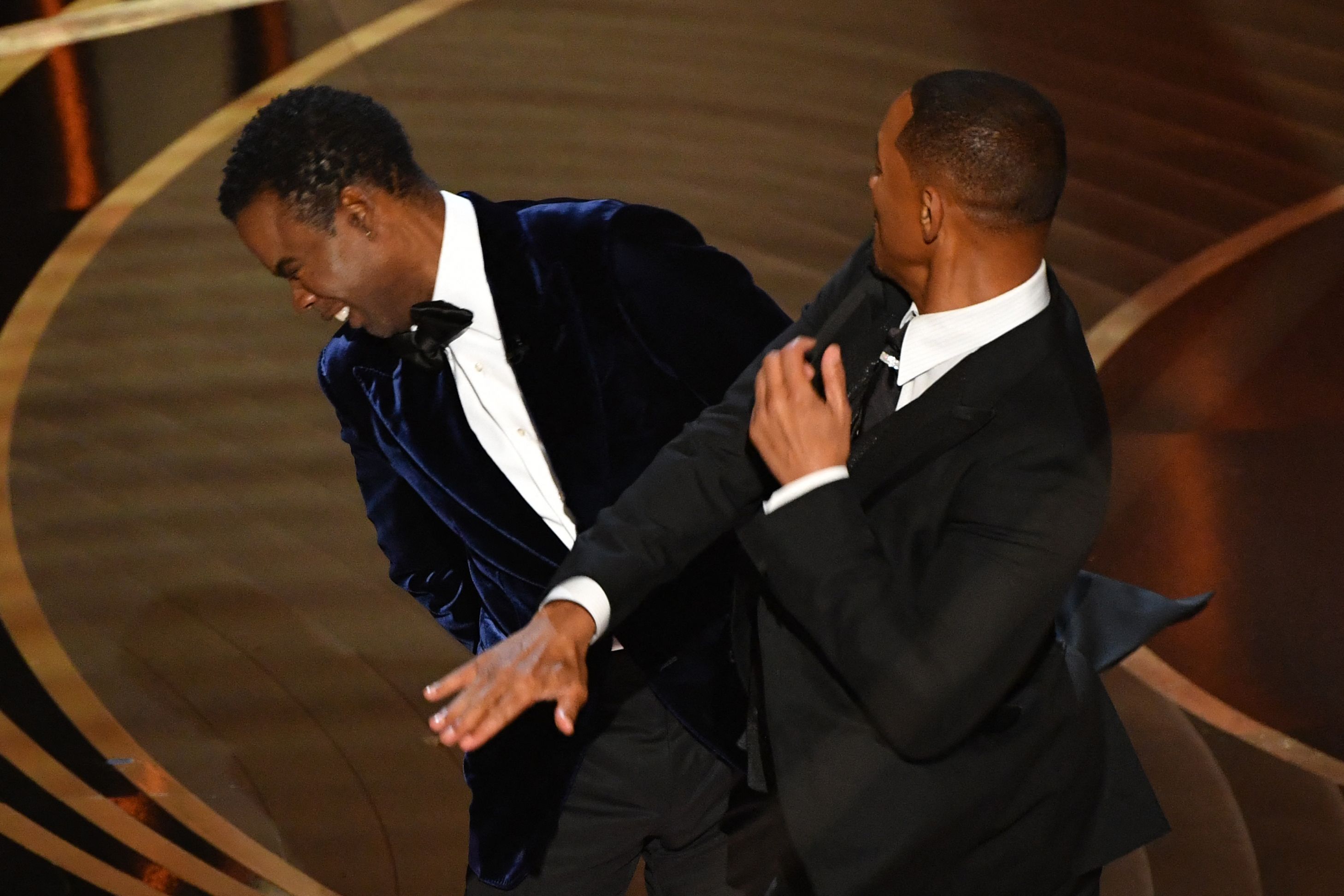 US actor Will Smith (R) slaps US actor Chris Rock onstage during the 94th Oscars at the Dolby Theatre in Hollywood, California, on March 27, 2022 | Source: Getty Images