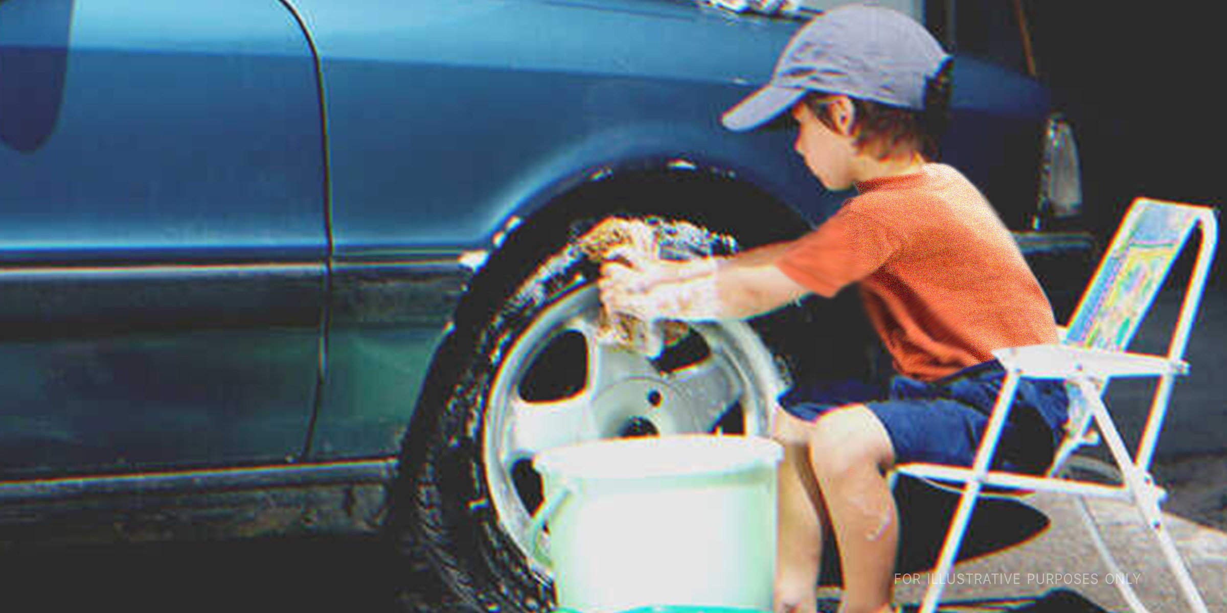 Little boy washing a car | Shutterstock