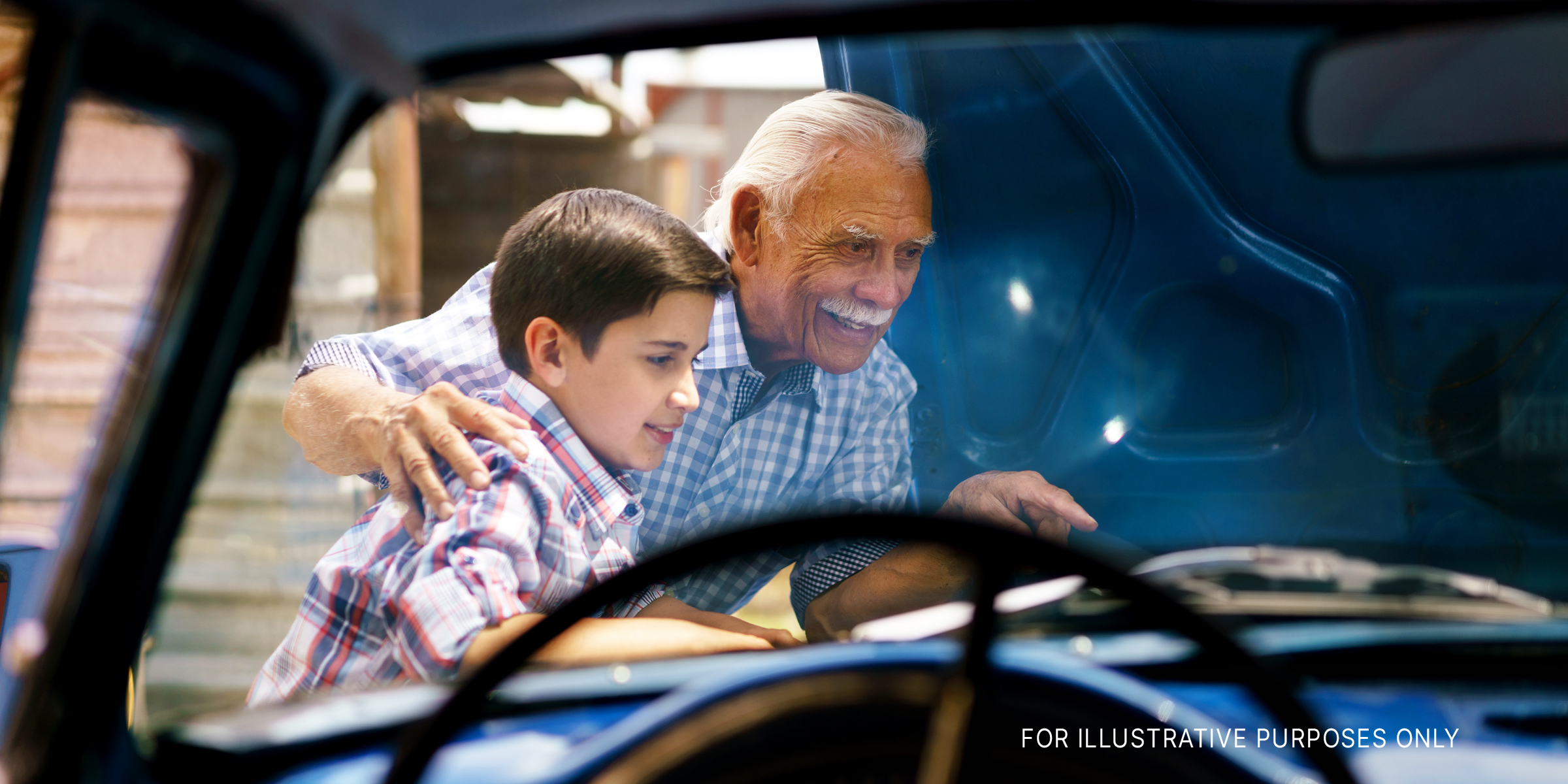 Old man and his grandson working on a car | Source: Shutterstock