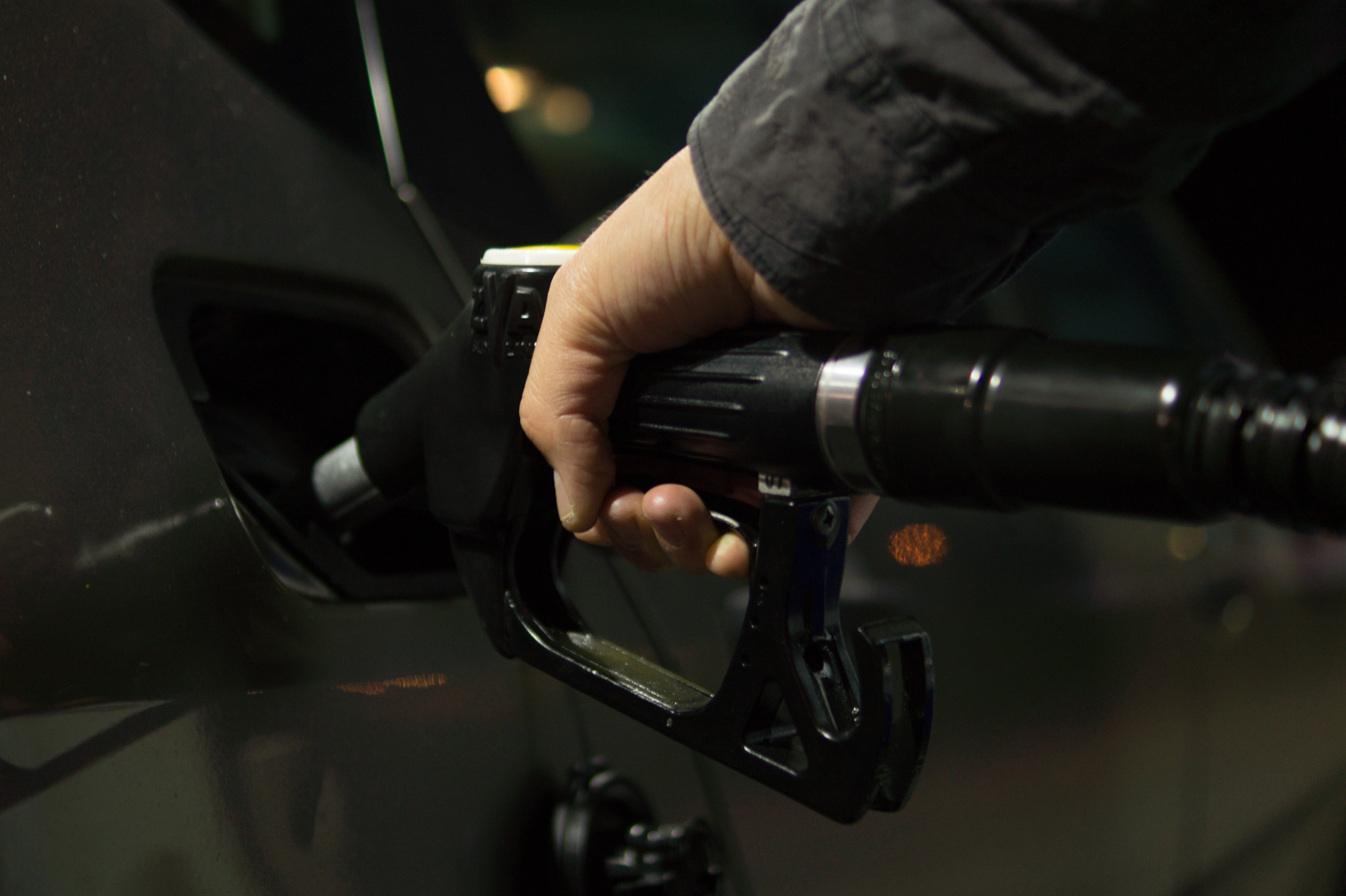 A man fills up his car with fuel at a gas station | Pexels/Skitterphoto