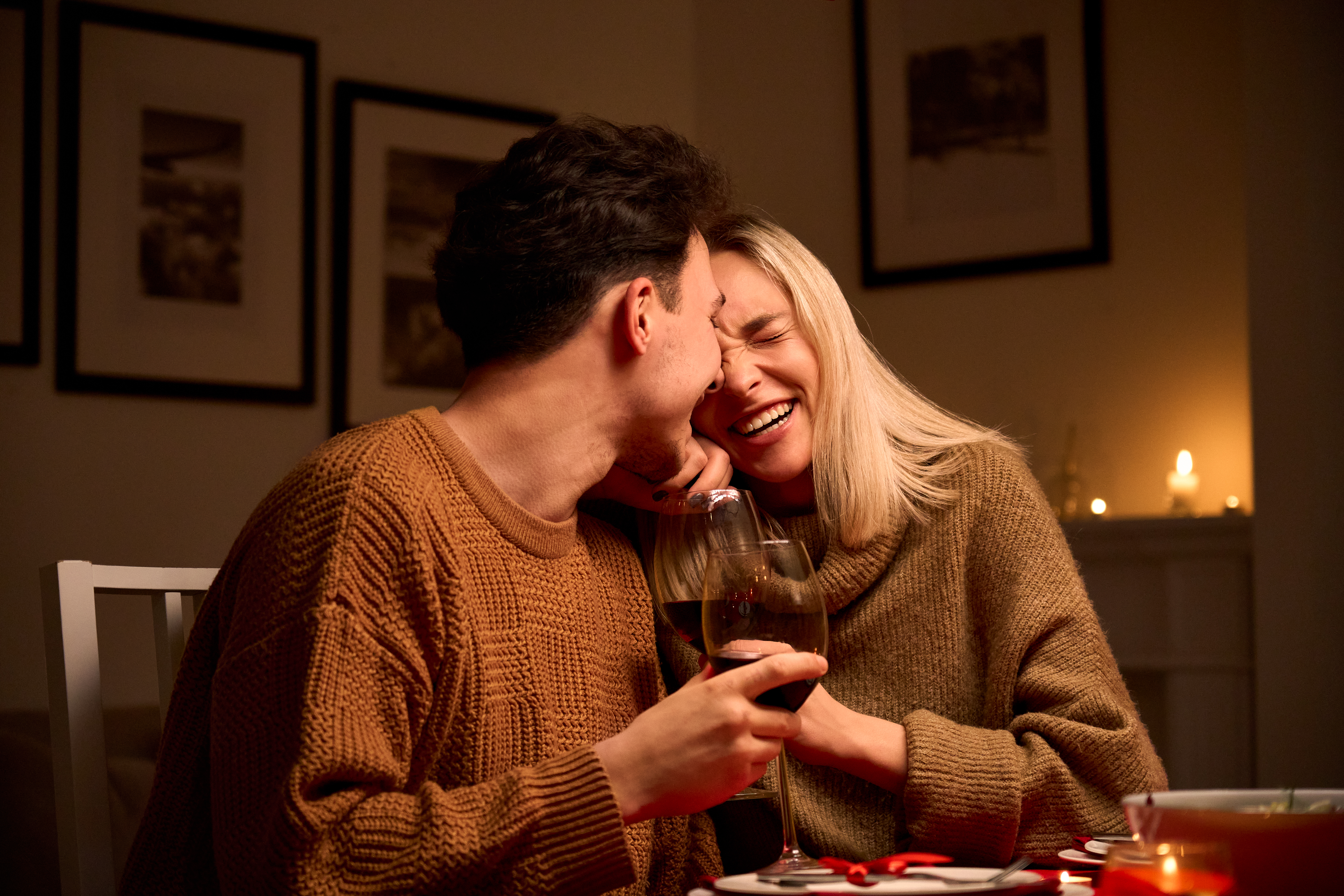 A woman and a man laughing at dinner | Source: Getty Images