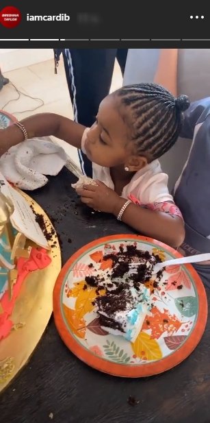 A picture of Kulture eating some cake on her mom's birthday. | Photo: Instagram/Iamcardib