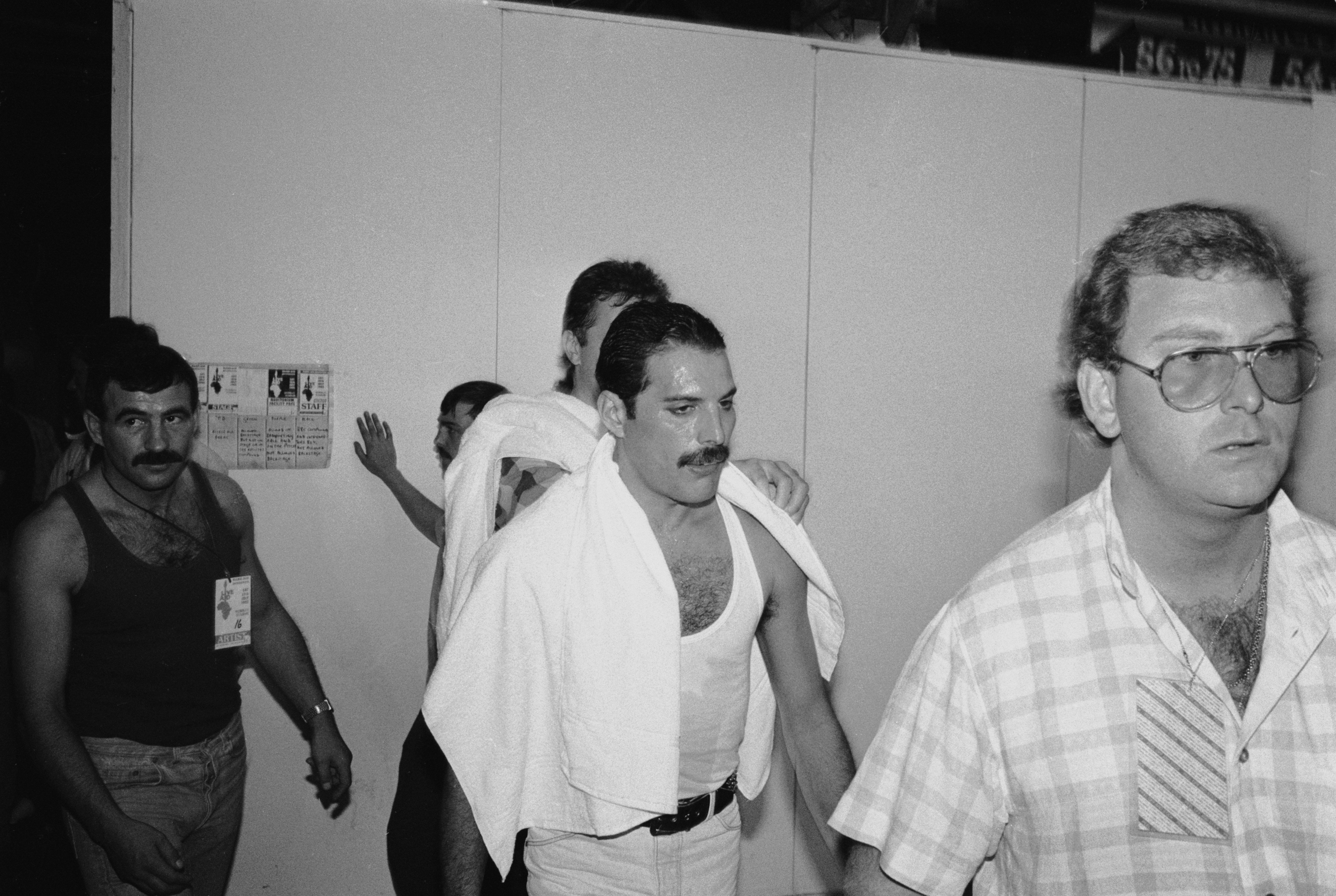 Freddie Mercury and his boyfriend, on the left, Jim Hutton, at the Live Aid concert at Wembley on July 13, 1985. | Source: Getty Images