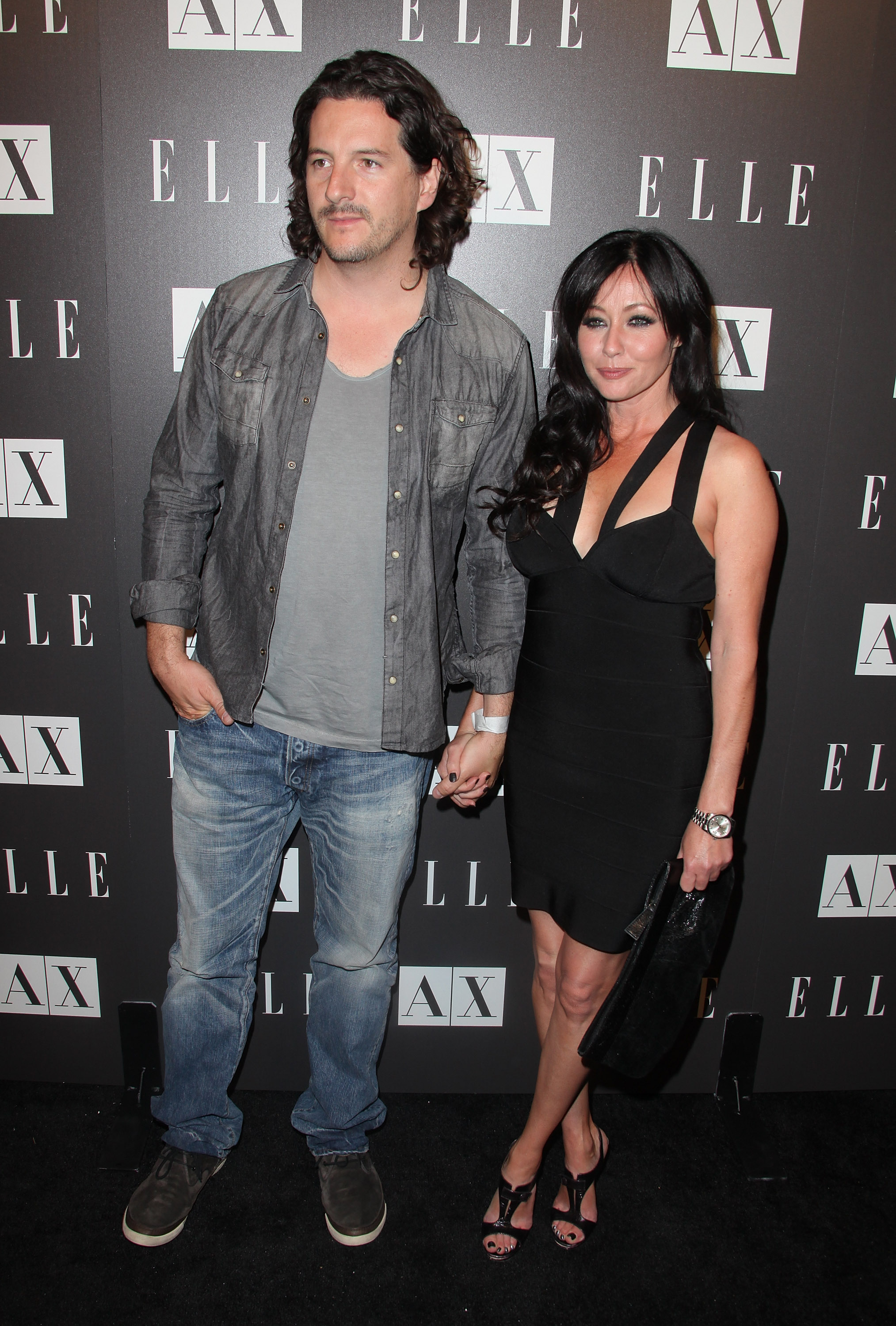 Kurt Iswarienko and Shannen Doherty arrive to A|X Armani Exchange and ELLE's Joe Zee's 'Disco Glam' soiree evening at A|X Robertson Store in Los Angeles, California on May 25, 2010. | Source: Getty Images
