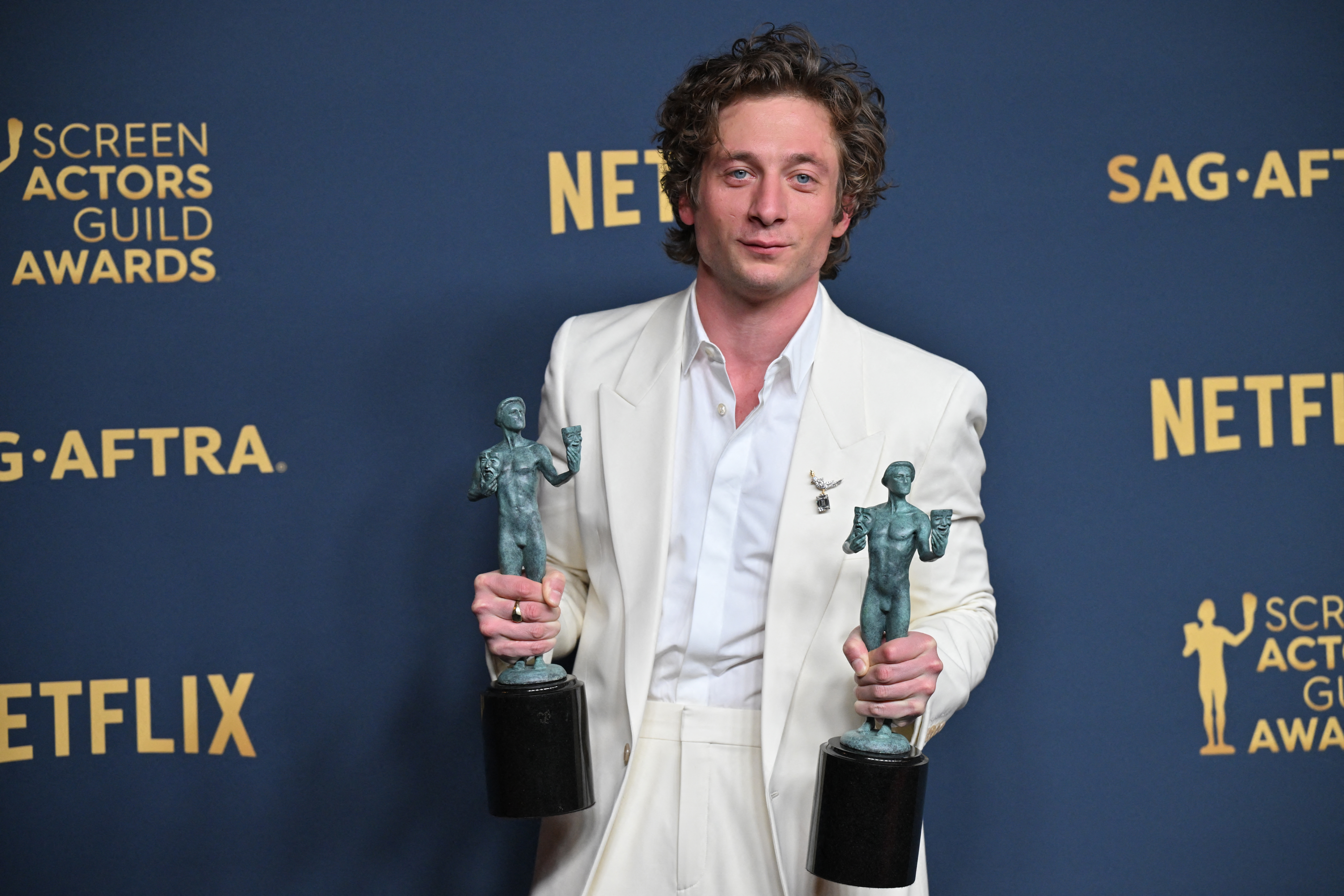 Jeremy Allen White holding up his trophies for Outstanding Performance by a Male Actor in a Comedy Series and Outstanding Performance by an Ensemble in a Comedy Series for "The Bear" during the 30th Annual Screen Actors Guild Awards on February 24, 2024 | Source: Getty Images