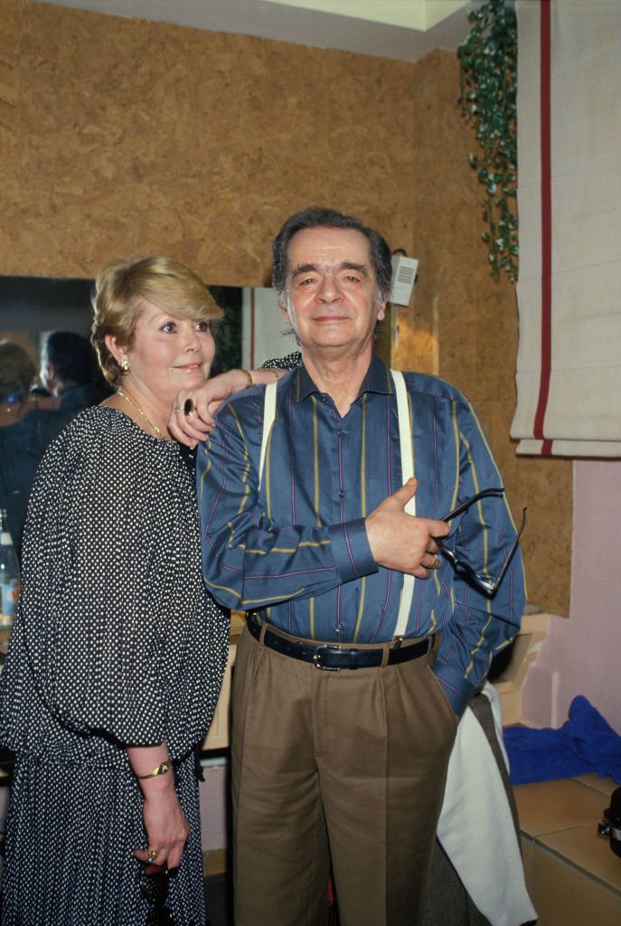 Serge Reggiani dans sa loge avec sa compagne Noëlle Adam lors de son concert à l'Olympia le 14 janvier 1986 à Paris, France. | Photo : Getty Images