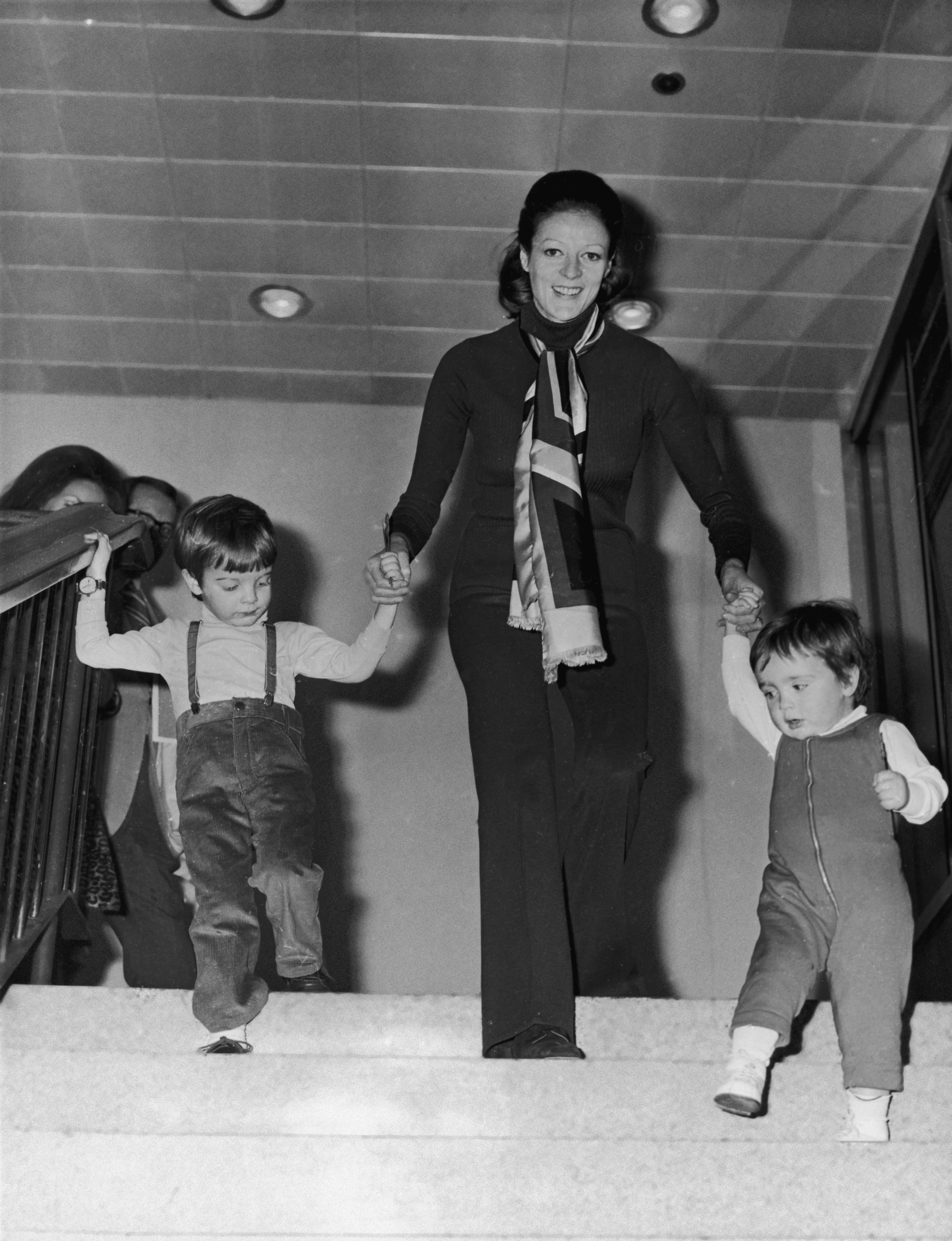 Maggie Smith with her two children, Chris Larkin and Toby at the London Airport in March 1971. | Source: Getty Images