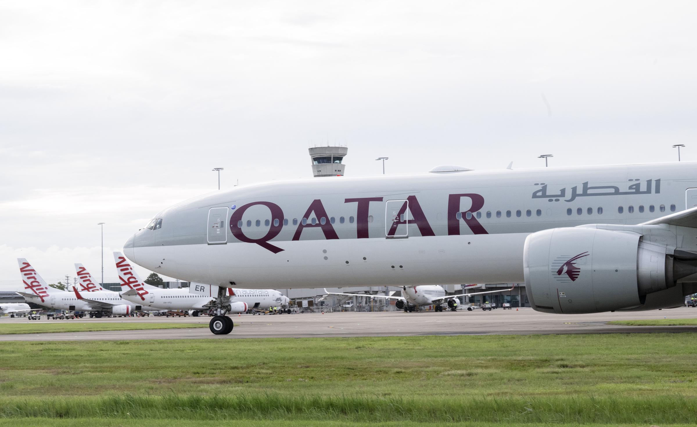 A Qatar Airways Boeing 777 passes Virgin Australia aircraft at Brisbane Airport on December 4, 2024, in Brisbane, Australia | Source: Getty Images