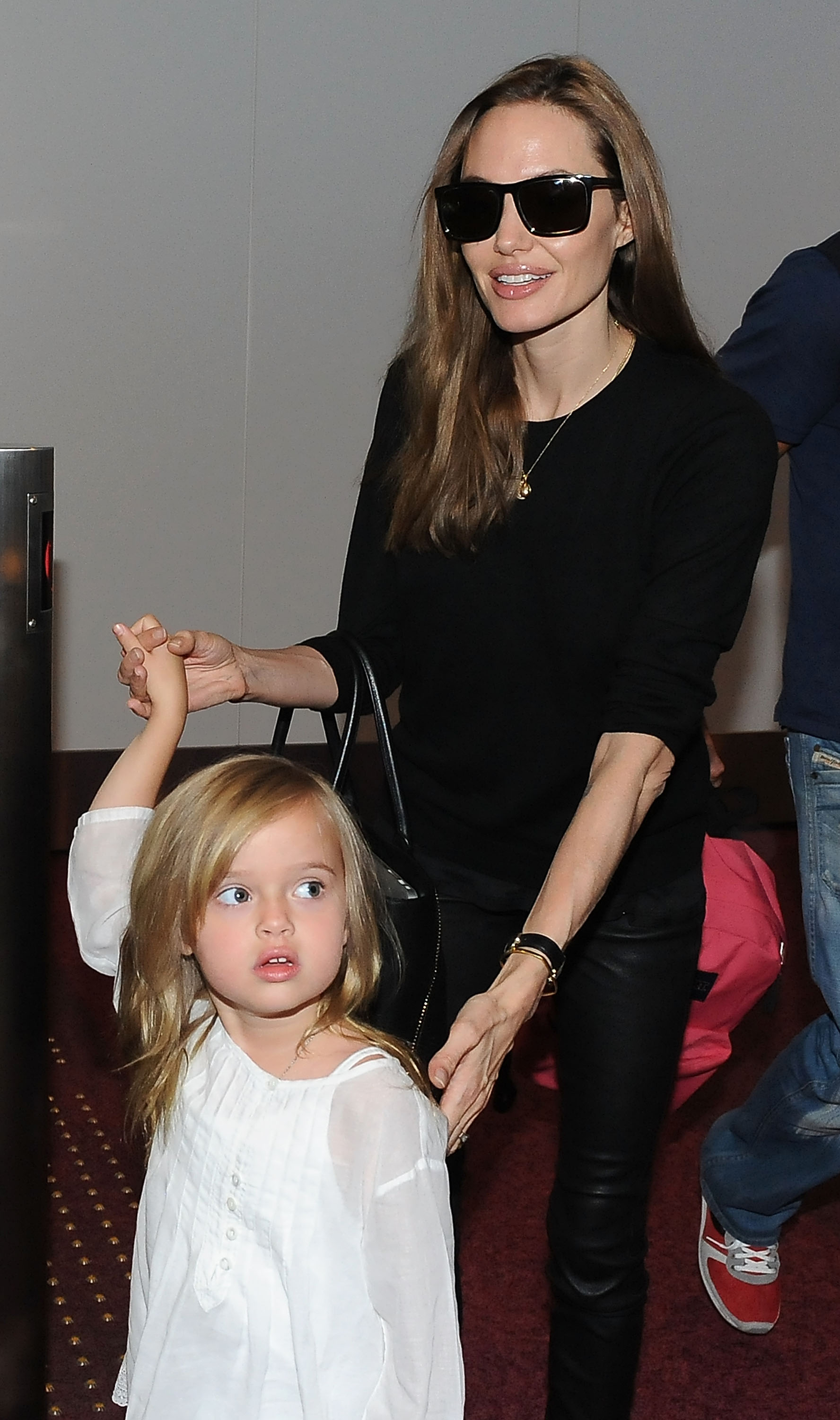 Angelina Jolie and her daughter Vivienne Jolie-Pitt at Tokyo International Airport in Tokyo, Japan on July 28, 2013 | Source: Getty Images