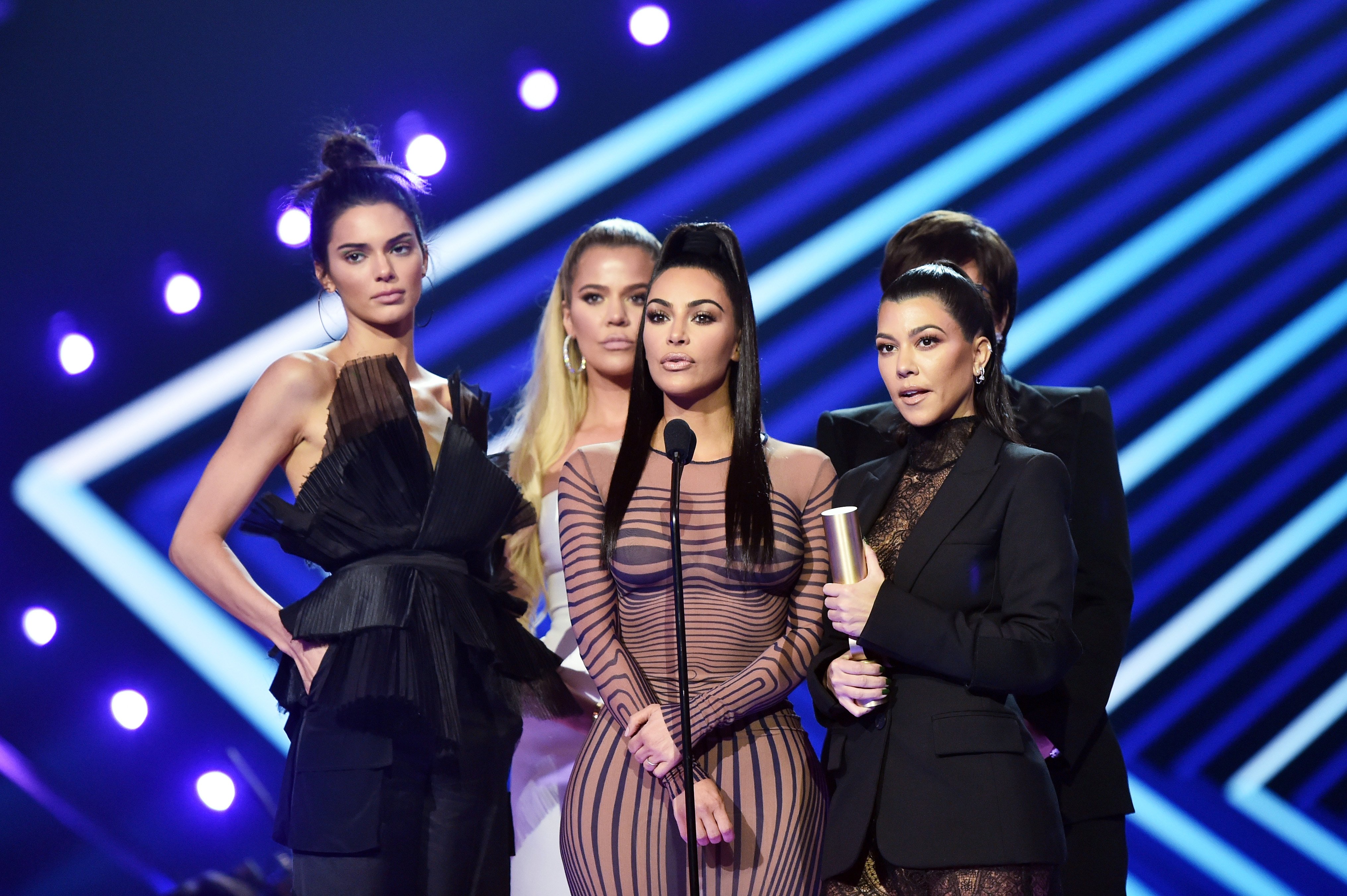 Khloe, Kim, and Kourtney Kardashian with Kris and Kendal Jenner on stage at E! People's Choice Awards at the Barker Hangar, Santa Monica, California, on November 11, 2018. | Source: Getty Images
