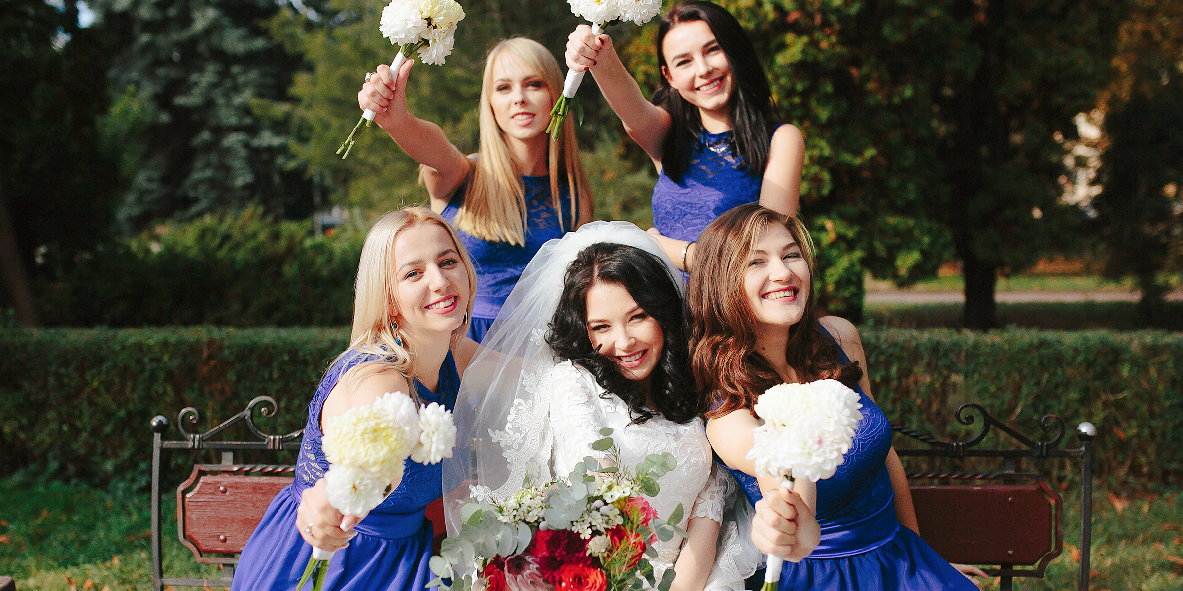 A happy bride surrounded by her bridesmaids | Source: Freepik