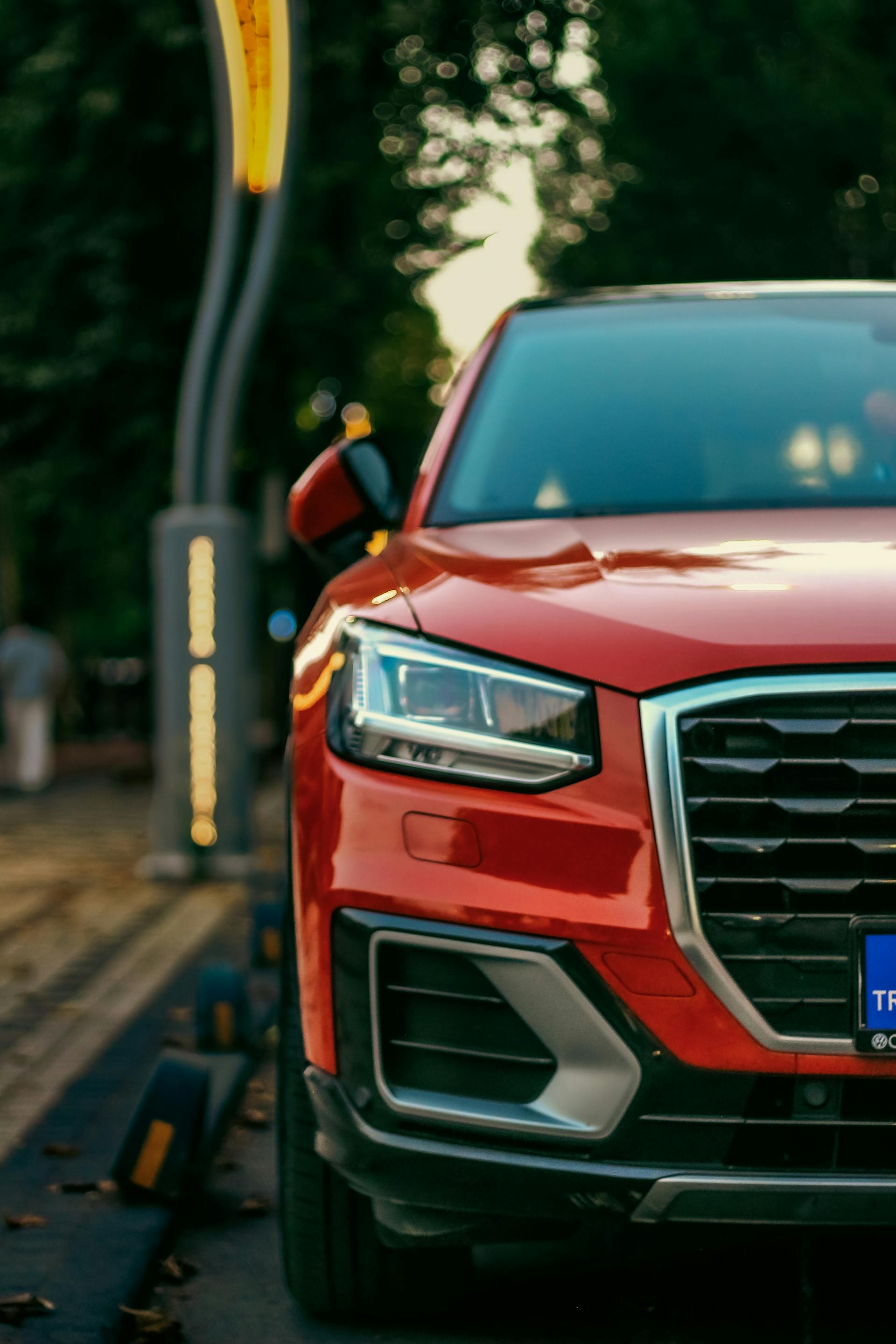 Close-up shot of a red SUV parked on the side of the road | Source: Pexels