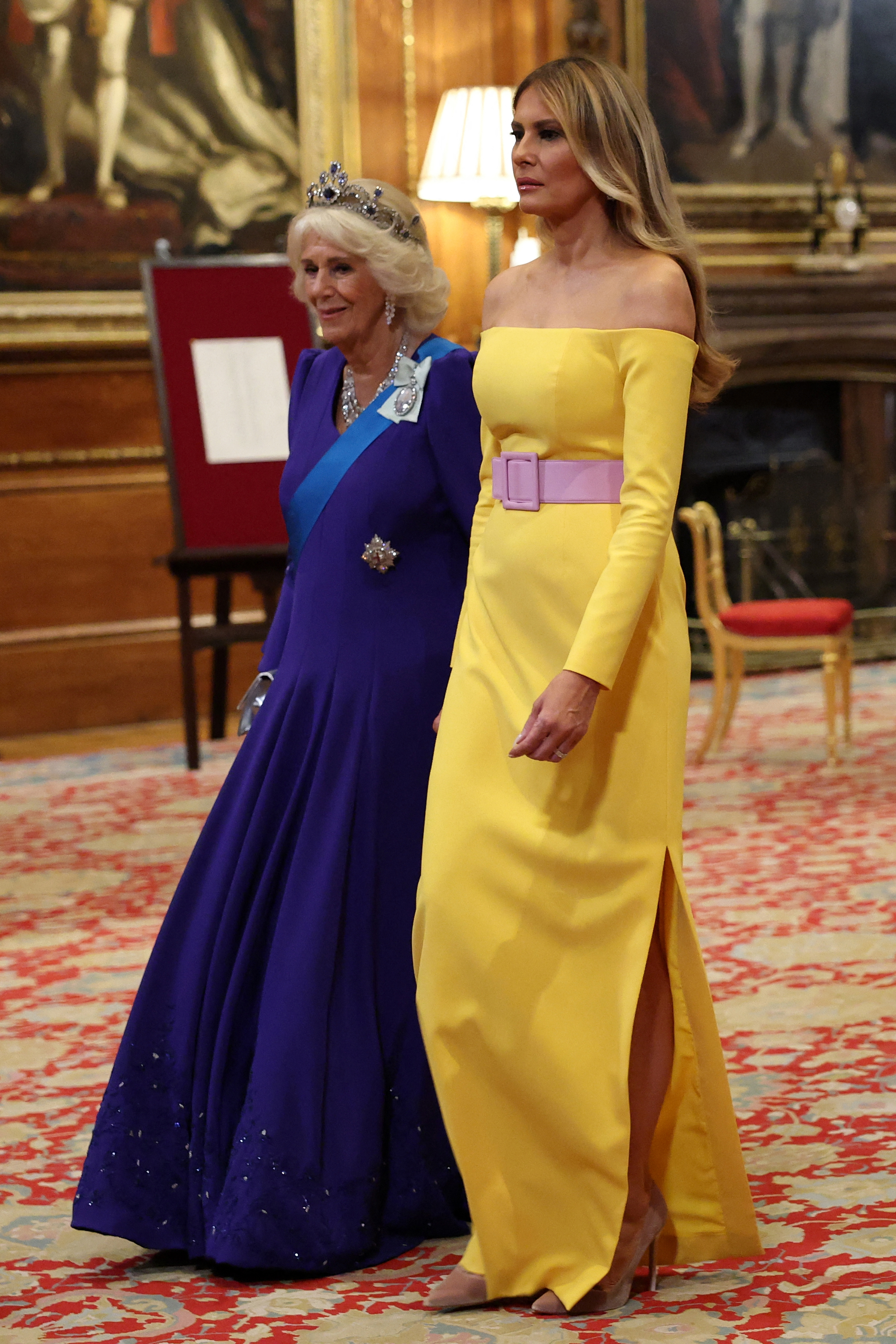 Queen Camilla and Melania Trump making their way through a hallway during the State Banquet. | Source: Getty Images