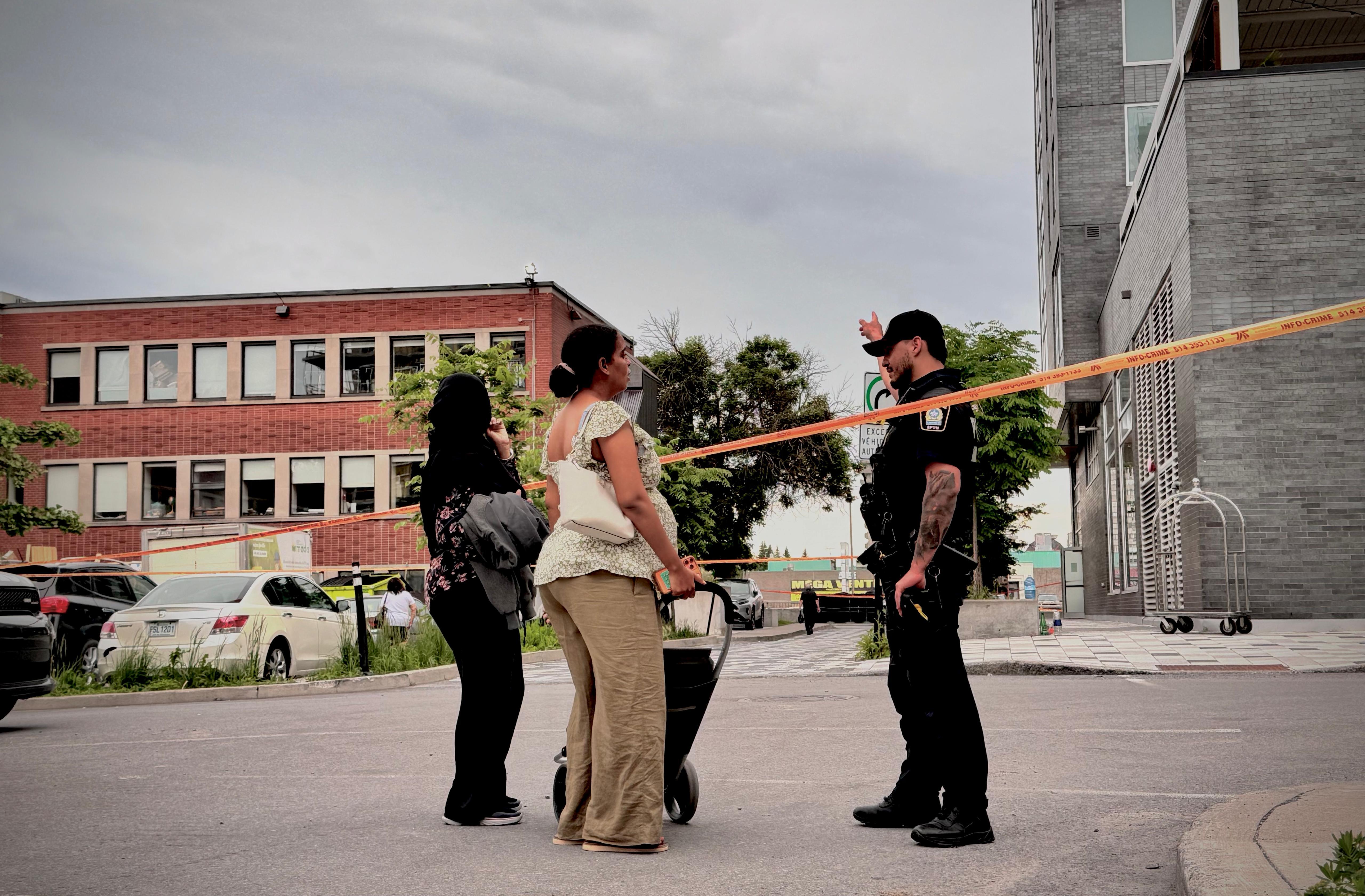 Police officers directed residents away from restricted areas as investigators worked at the scene. The shooting prompted a large emergency response and left many people searching for information about what had happened. | Source: Getty Images