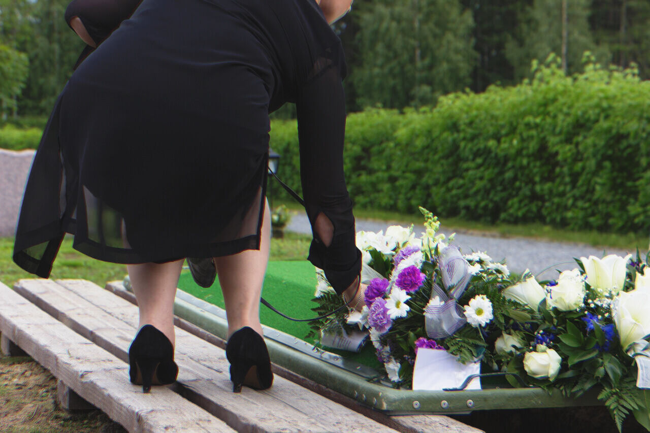 Grieving woman clad in black attire at a funeral | Source: Shutterstock