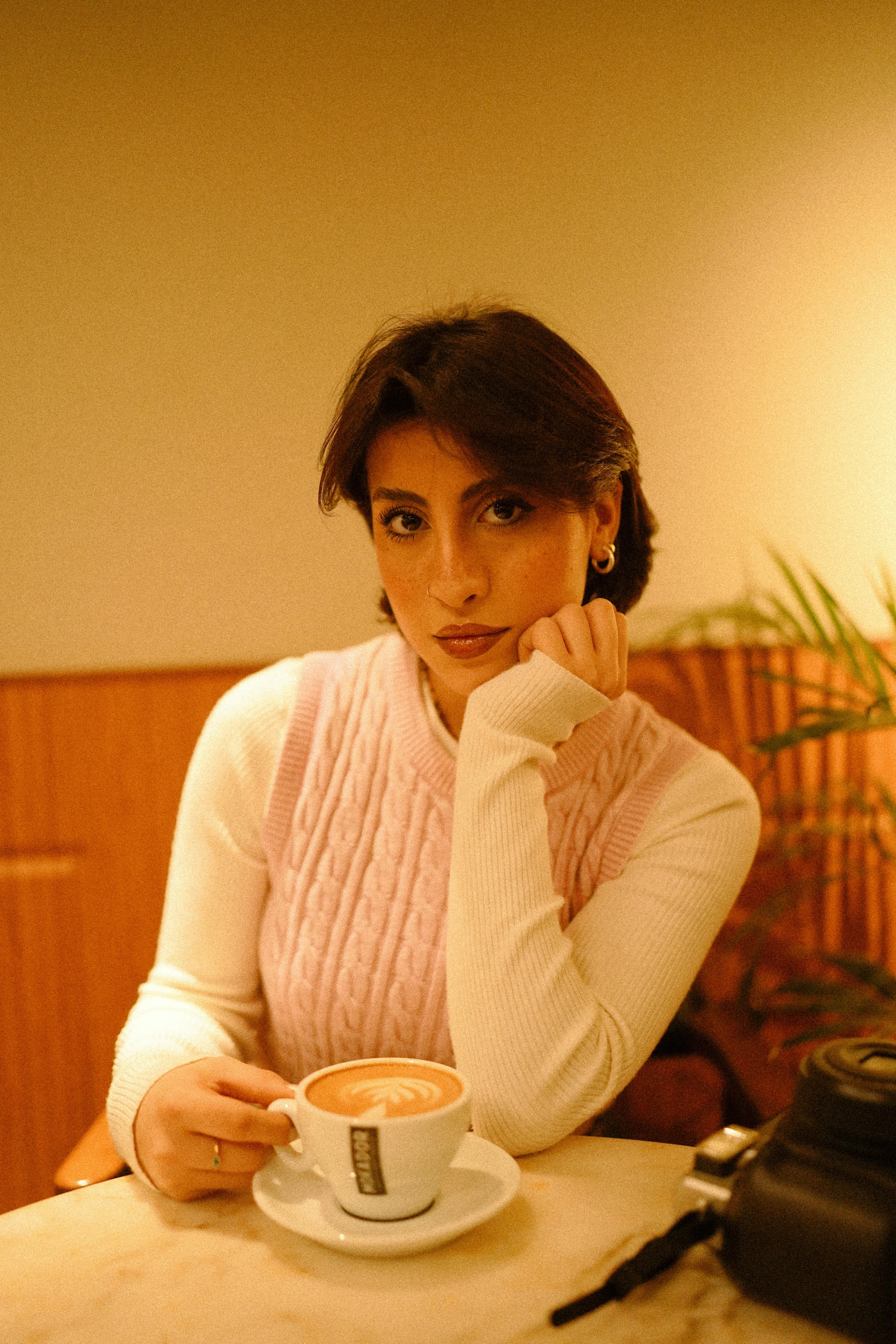 A woman looking unimpressed while having coffee | Source: Pexels