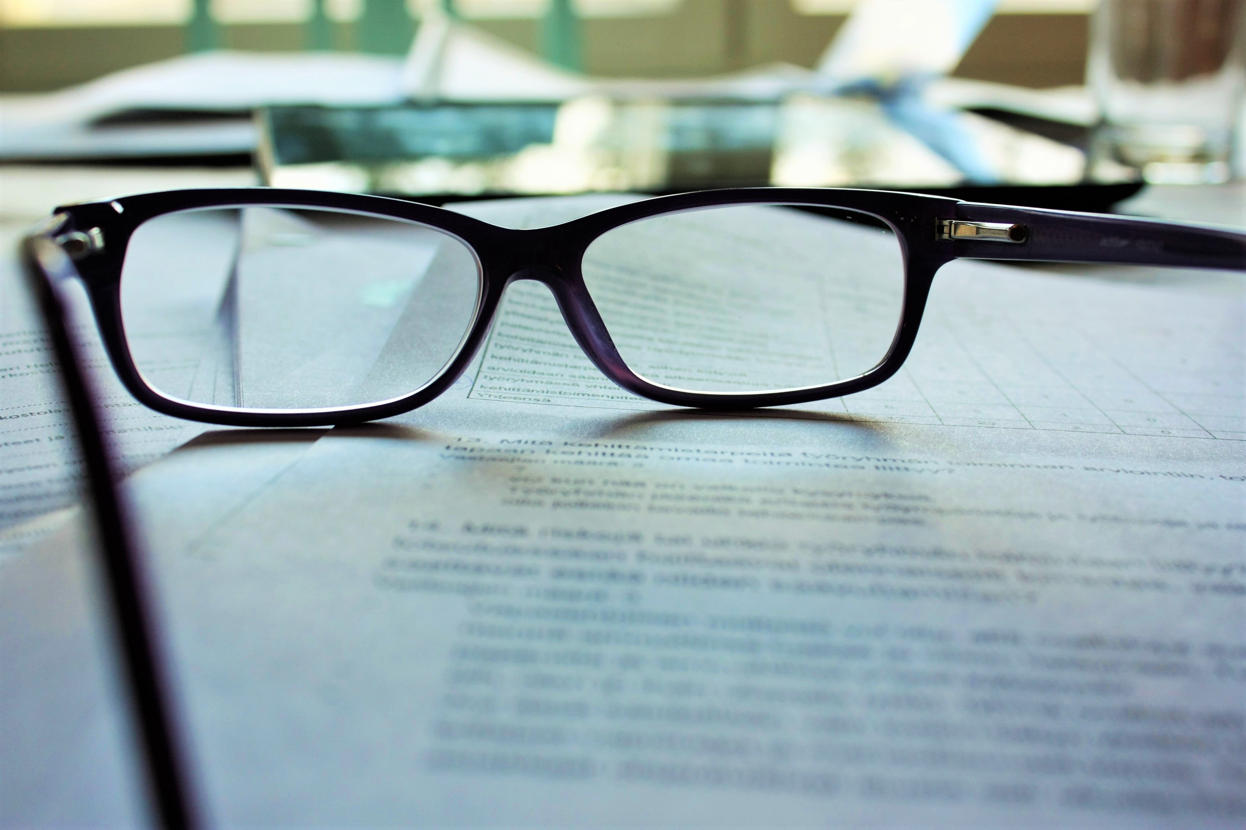 Reading glasses and papers | Source: Unsplash