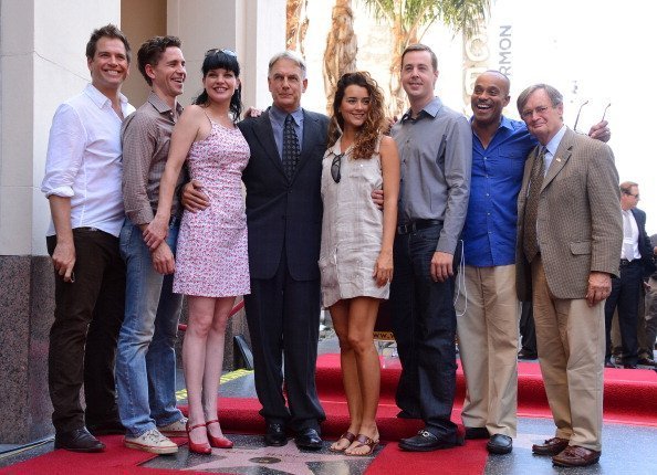 Actors Michael Weatherly, Brian Dietzen, Pauley Perrette, Mark Harmon, Cote de Pablo, Sean Murray, Rocky Caroll and David McCallum pose as actor Mark Harmon is honored with the 2,482nd star on the Hollywood Walk of Fame on October 1, 2012, in Hollywood, California. | Source: Getty Images.