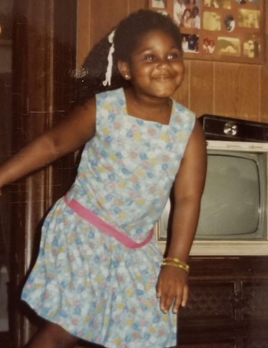 The actress smiling and playing at home as a young girl | Source: Instagram/gabbysidibe