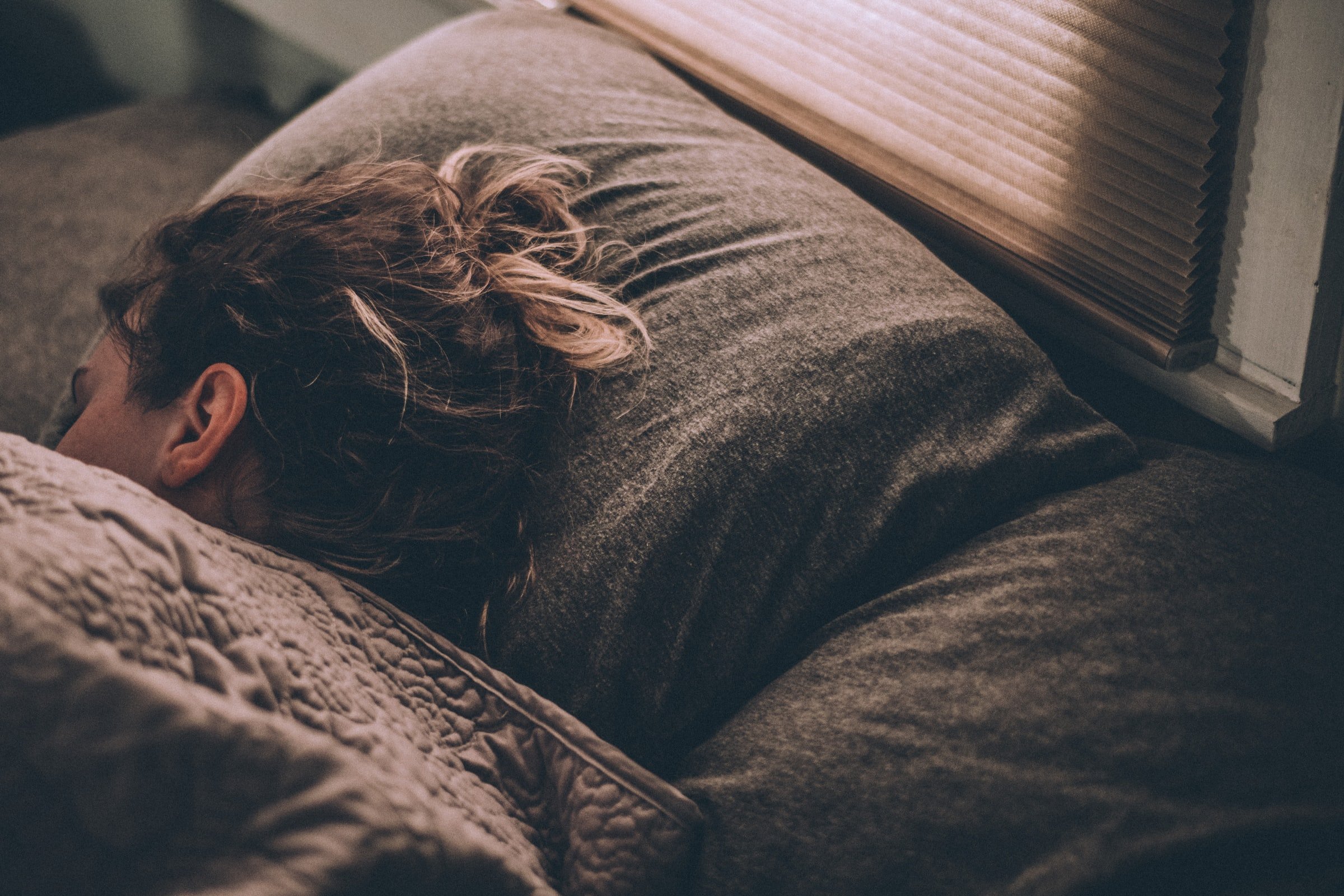 A woman sleeping on the bed. | Source: Unsplash