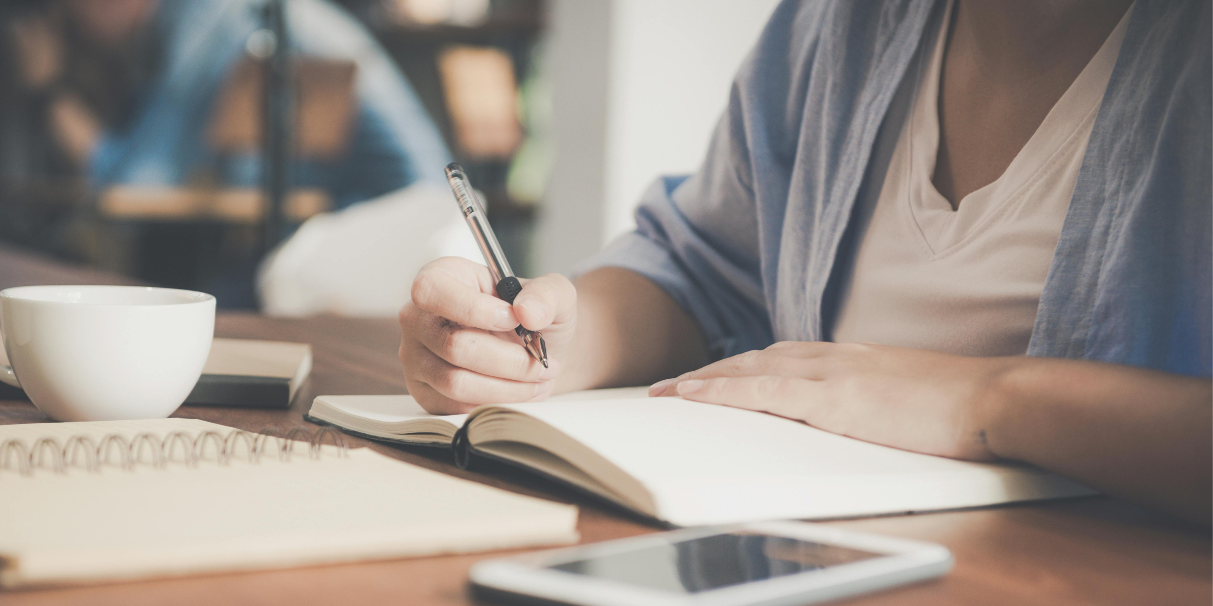 A woman journaling | Source: Pexels