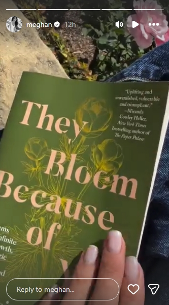 Meghan holds up a copy of "They Bloom Because of You: Poems on the Infinite Love, Growth, and Magic of Motherhood" by Jessica Urlichs, its dark olive-green cover catching the outdoor light as pink roses bloom softly out of focus in the background. Her neatly manicured hand holds the book open towards the camera, the title clearly legible across the front. | Source: Instagram/meghan