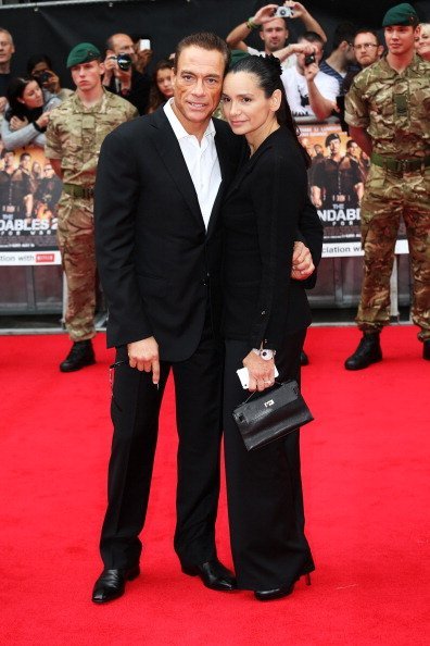 Jean-Claude Van Damme (L) and Gladys Portugues attend "The Expendables 2" UK film premiere at Empire Leicester Square on August 13, 2012, in London, England. | Source: Getty Images.