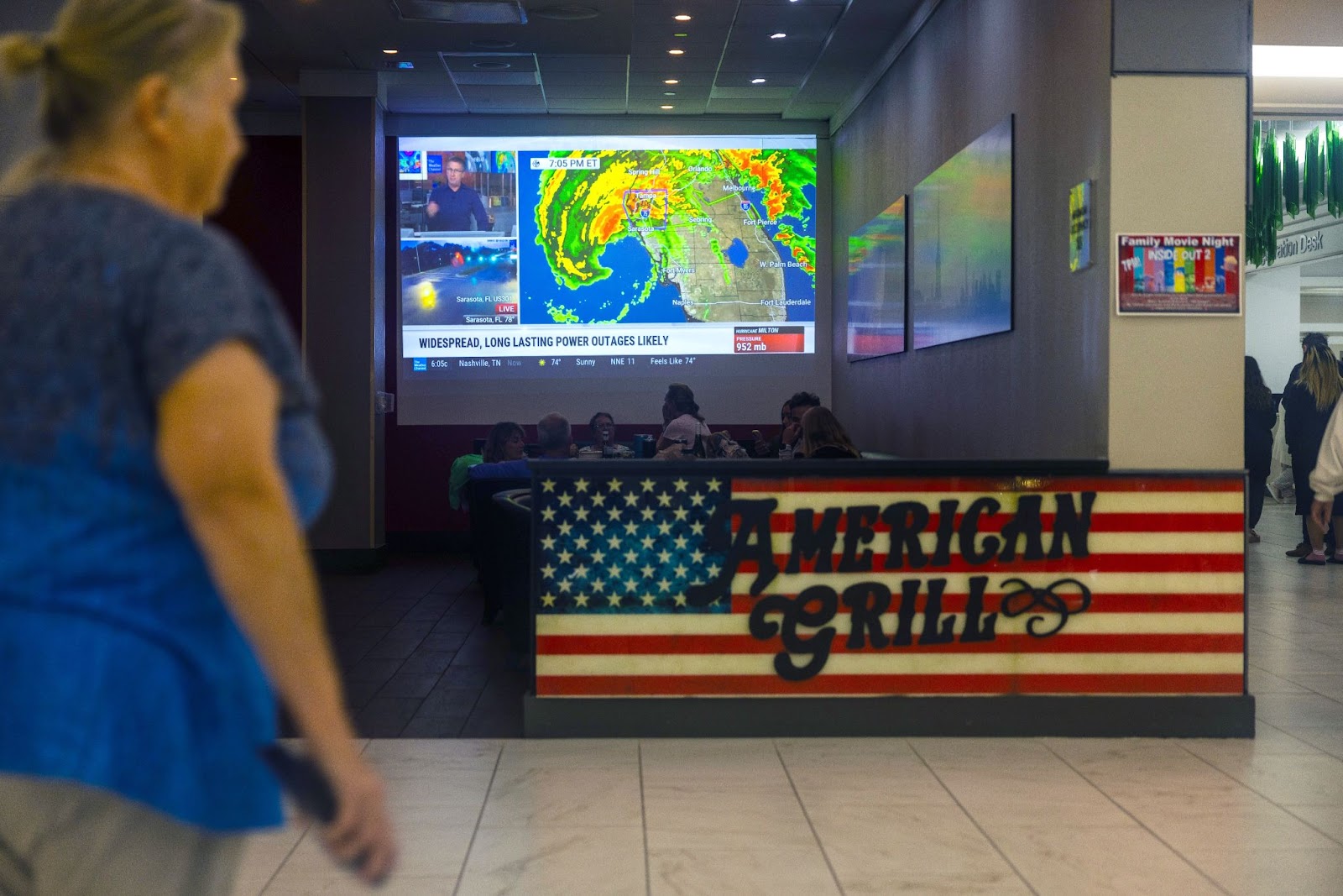 People watching the weather report ahead of Hurricane Milton. | Source: Getty Images