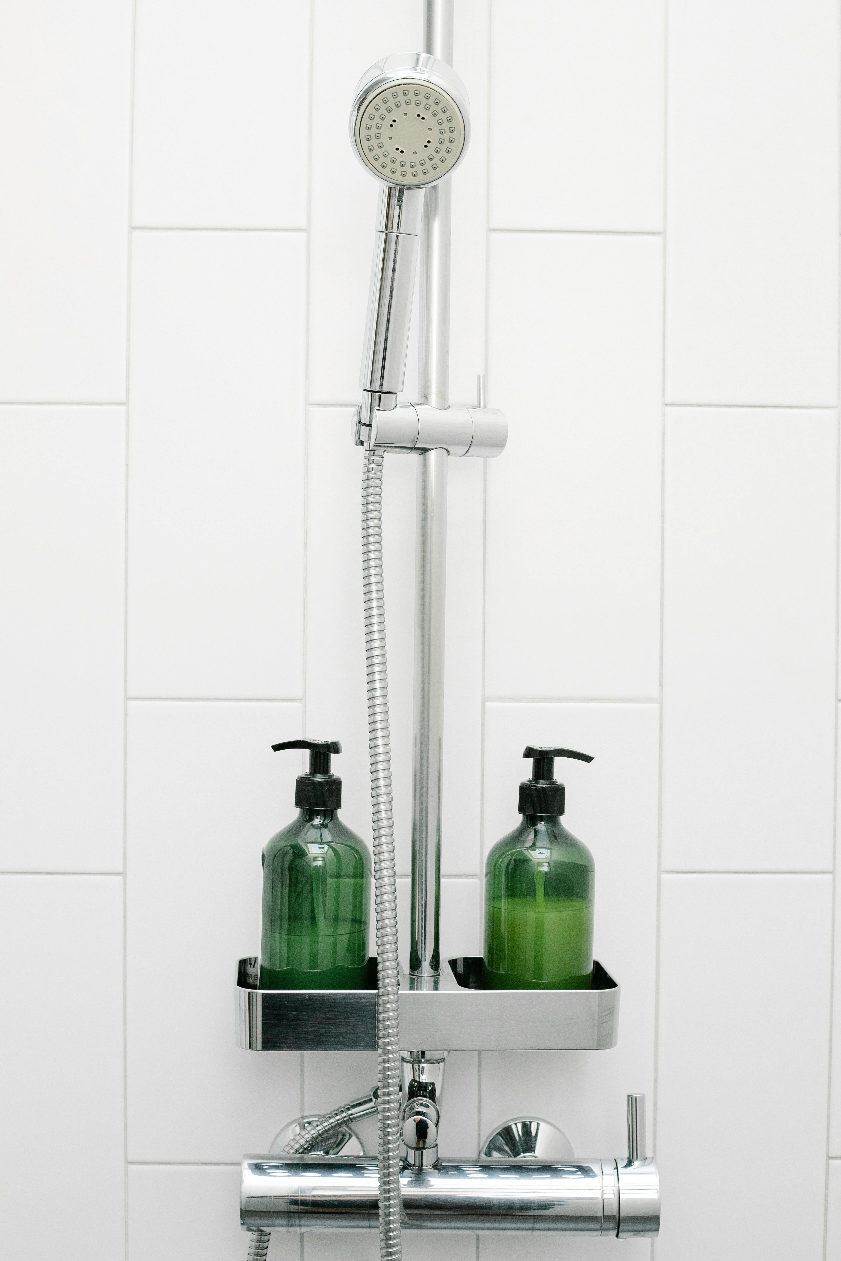 A shower caddy with shampoo and soap dispensers | Source: Pexels