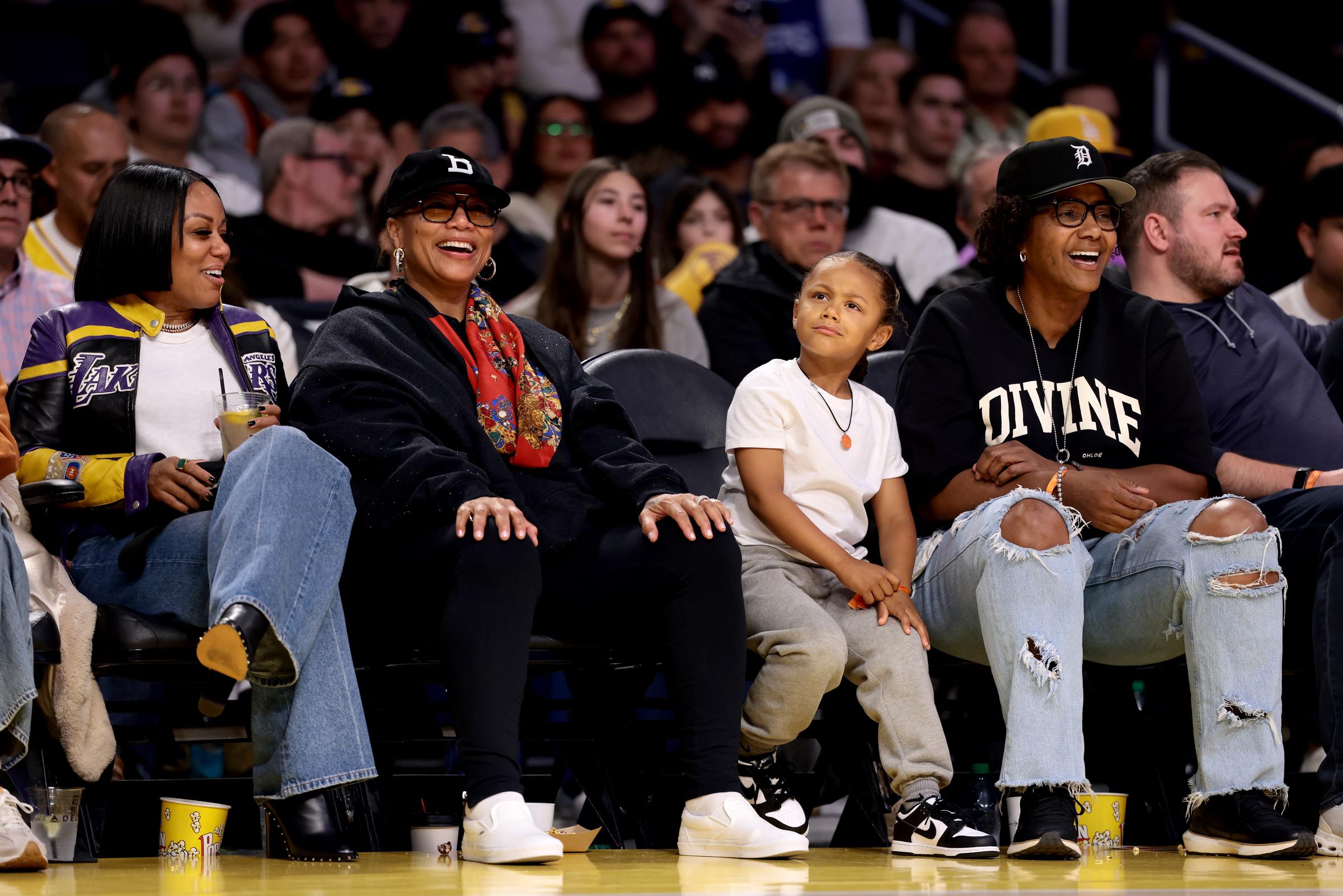 Eboni Nichols, Queen Latifah, and Rebel watching the basketball game. | Source: Getty Images