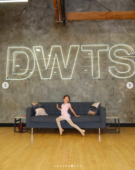 Olivia Efron posing underneath the "DWTS" backdrop in the dance studio. | Source: Instagram/dylanefron