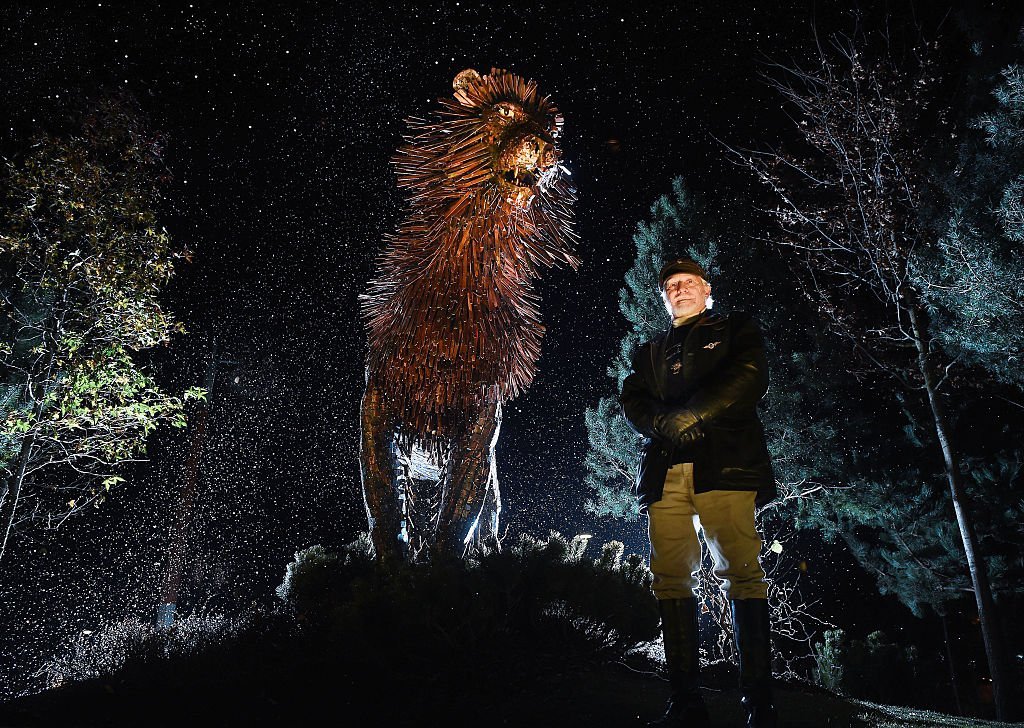 Douglas Gresham, the adopted son of the children's author CS Lewis stands beside a bronze sculpture of CS Lewis' most famous character the lion Aslan as he helps open CS Lewis Square | Getty Images