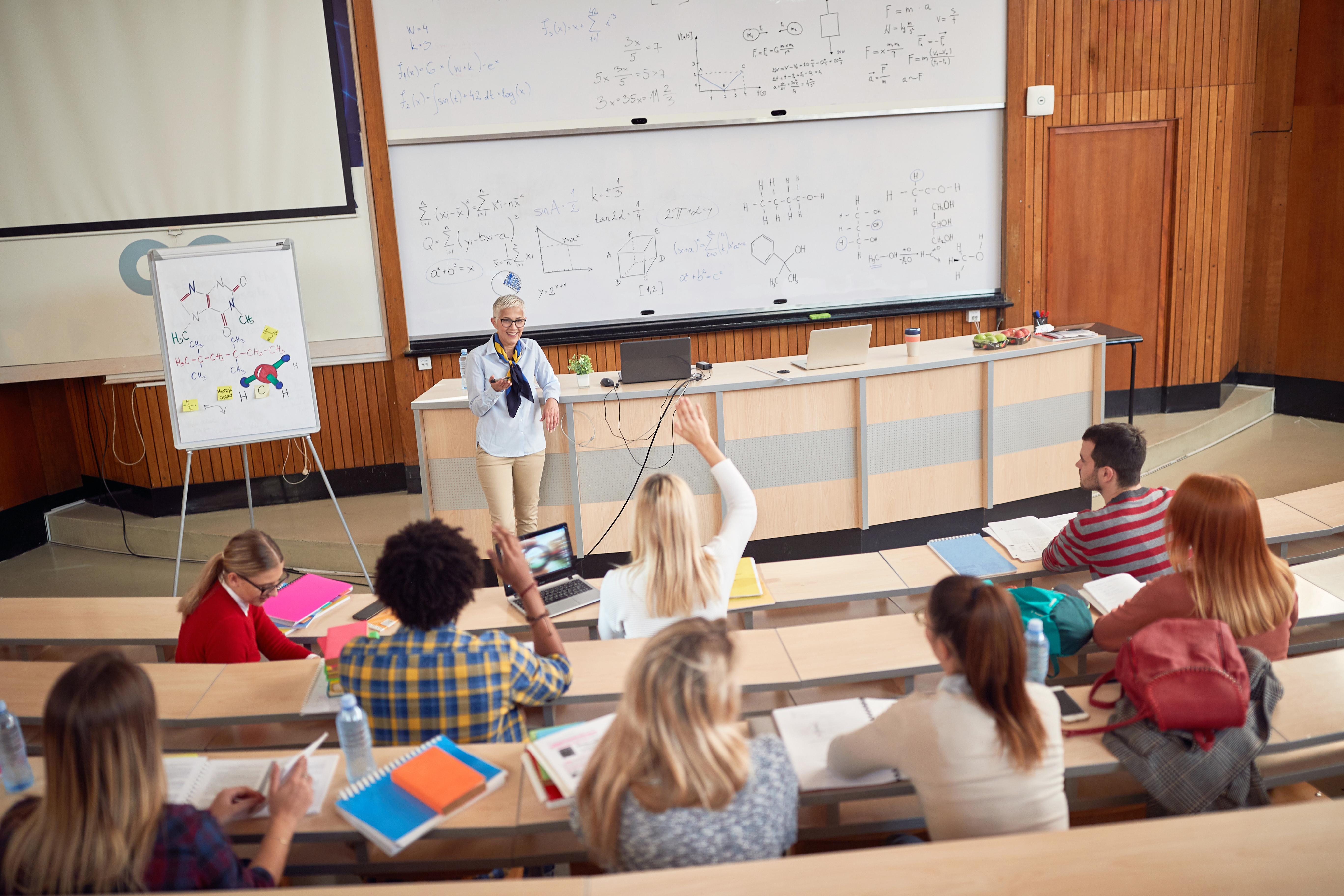 A professor with students in the lecture hall  | Source: Shutterstock