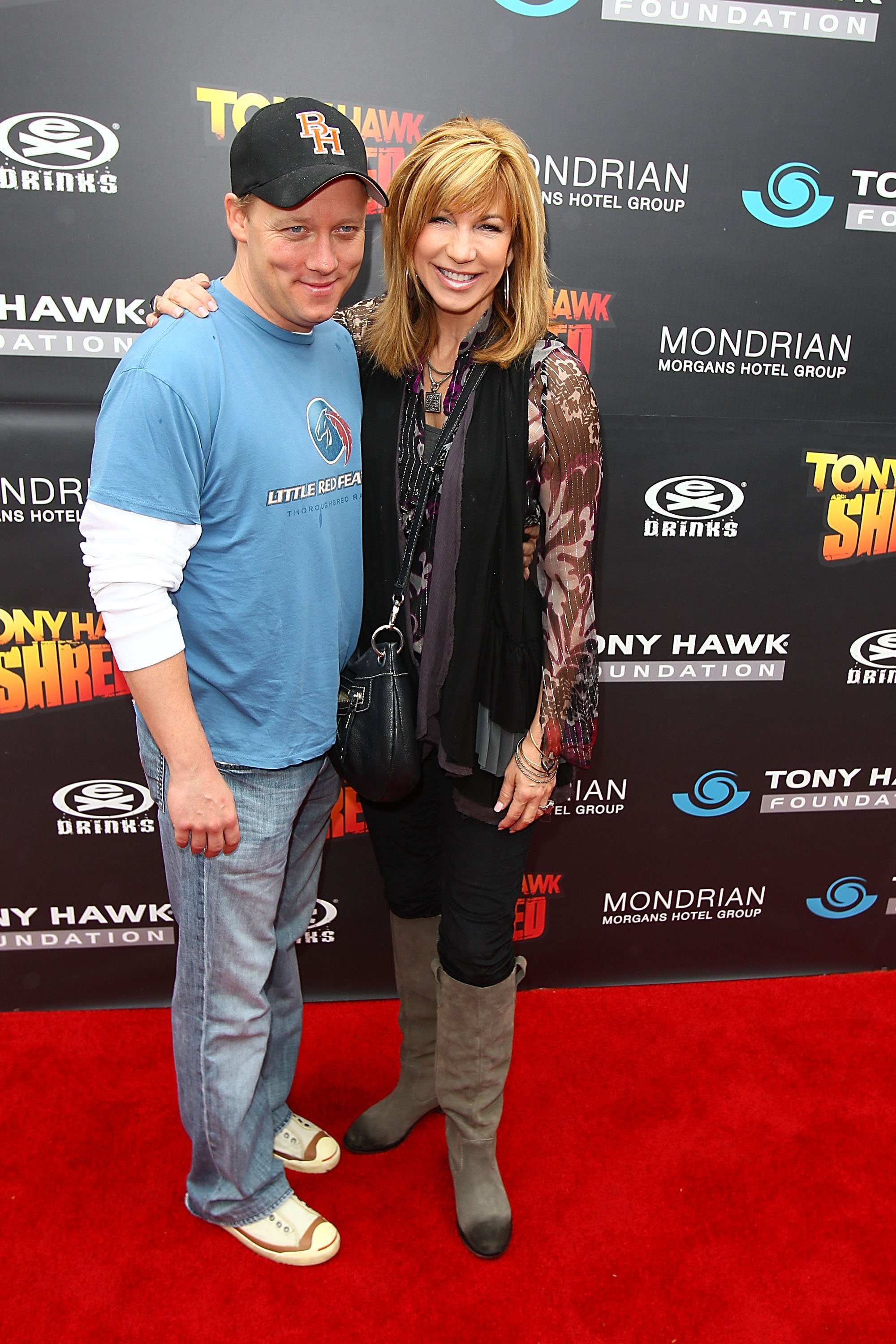 Leeza Gibbons and Steven Fenton pose on the red carpet at the Tony Hawk: Shred Presents Stand Up For Skateparks Benefit on October 17, 2010, in Beverly Hills | Source: Getty Images