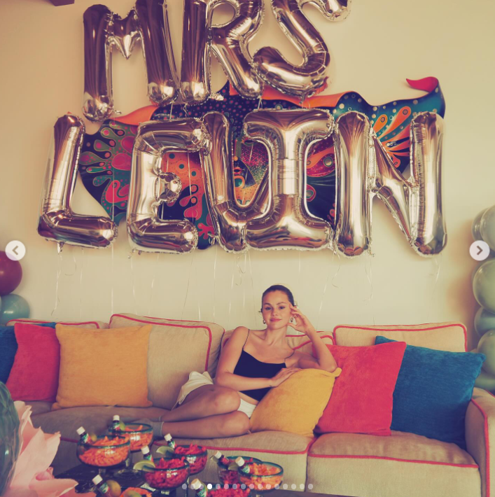 Selena Gomez sits on a couch surrounded by throw pillows, from a post dated August 29, 2025 | Source: Instagrm/selenagomez