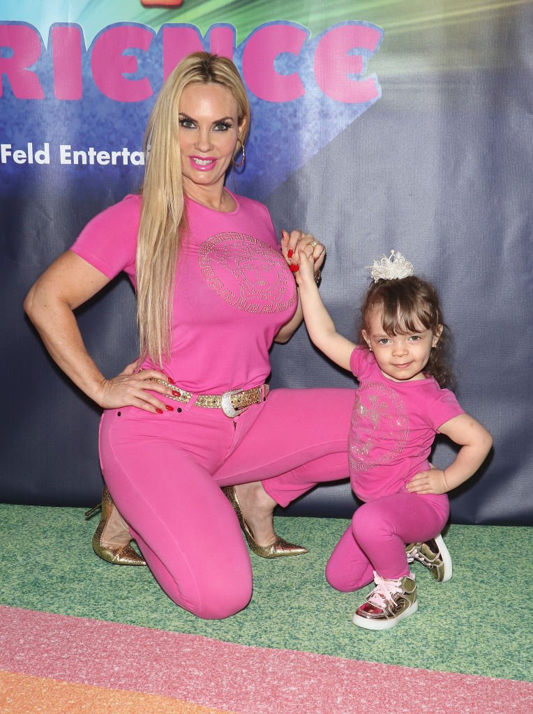 Coco Austin and her daughter Chanel Nicole Marrow pose with their hips to the side as the arrived at the Dreamworks Trolls The Experience opening on November 14, 2018, New York City | Source: Jim Spellman/Getty Images