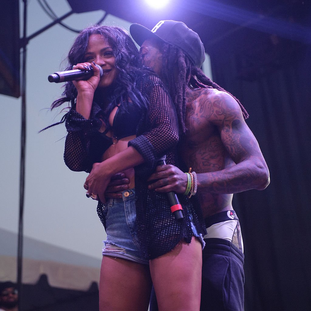 Christina Milian et Lil Wayne se produisent en direct lors du festival de musique Billboard Hot 100 2015 au Nikon at Jones Beach Theater, le 22 août 2015 à Wantagh, New York. | Photo : Getty Images