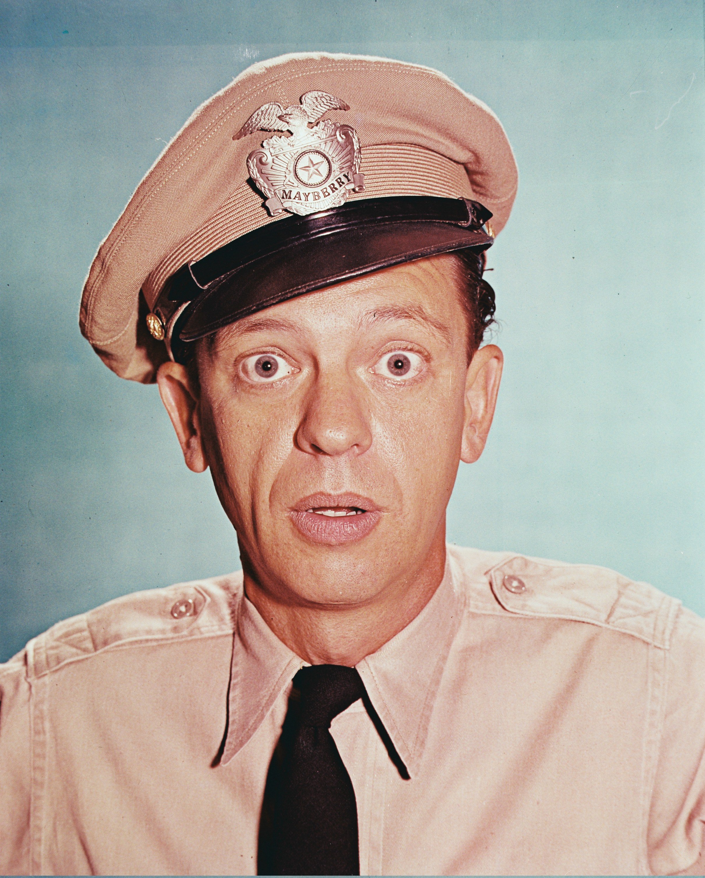 Don Knotts, US actor, in costume in a studio portrait, against a blue background, issued as publicity for the television series. | Source: Getty Images