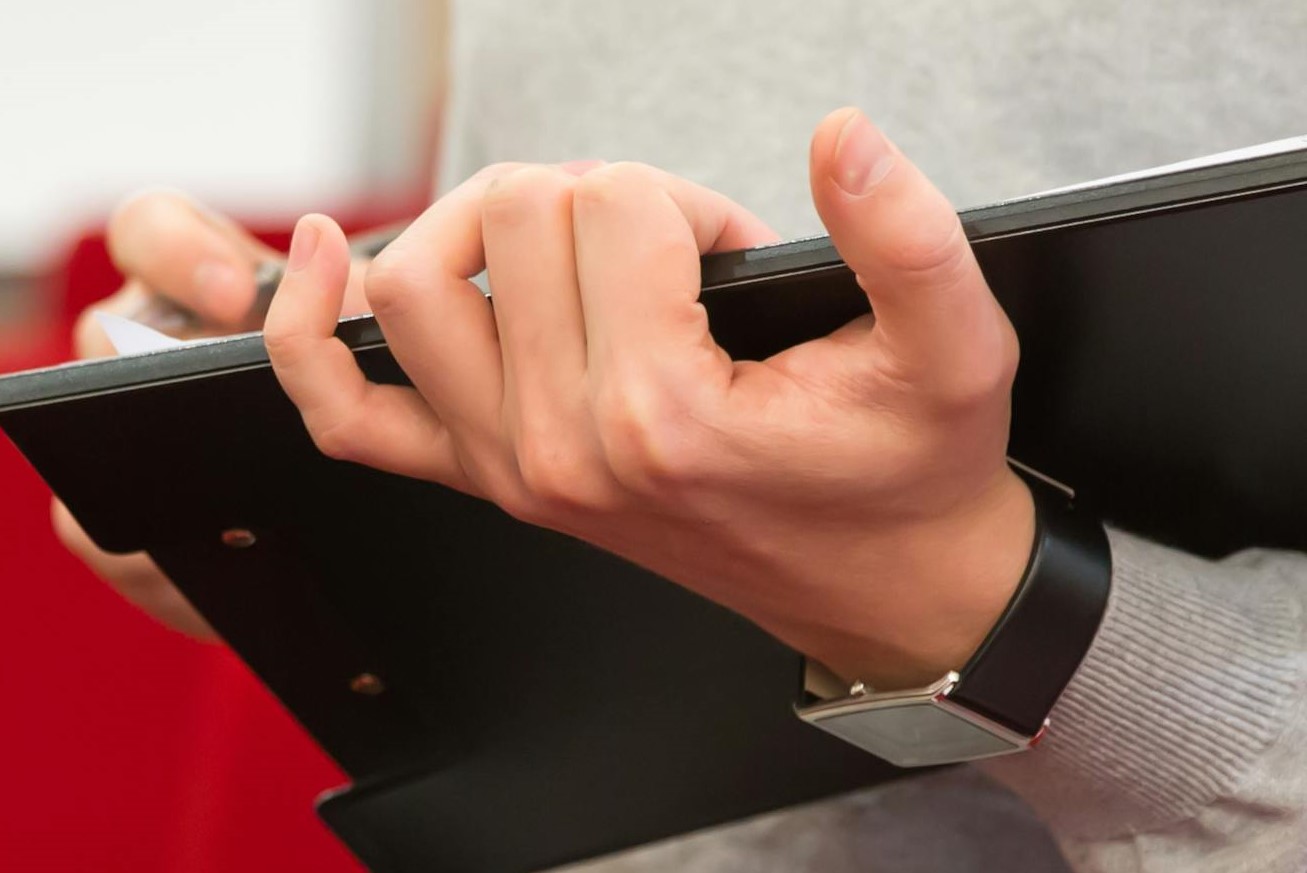 Close-up of a man holding a folder | Source: Pexels