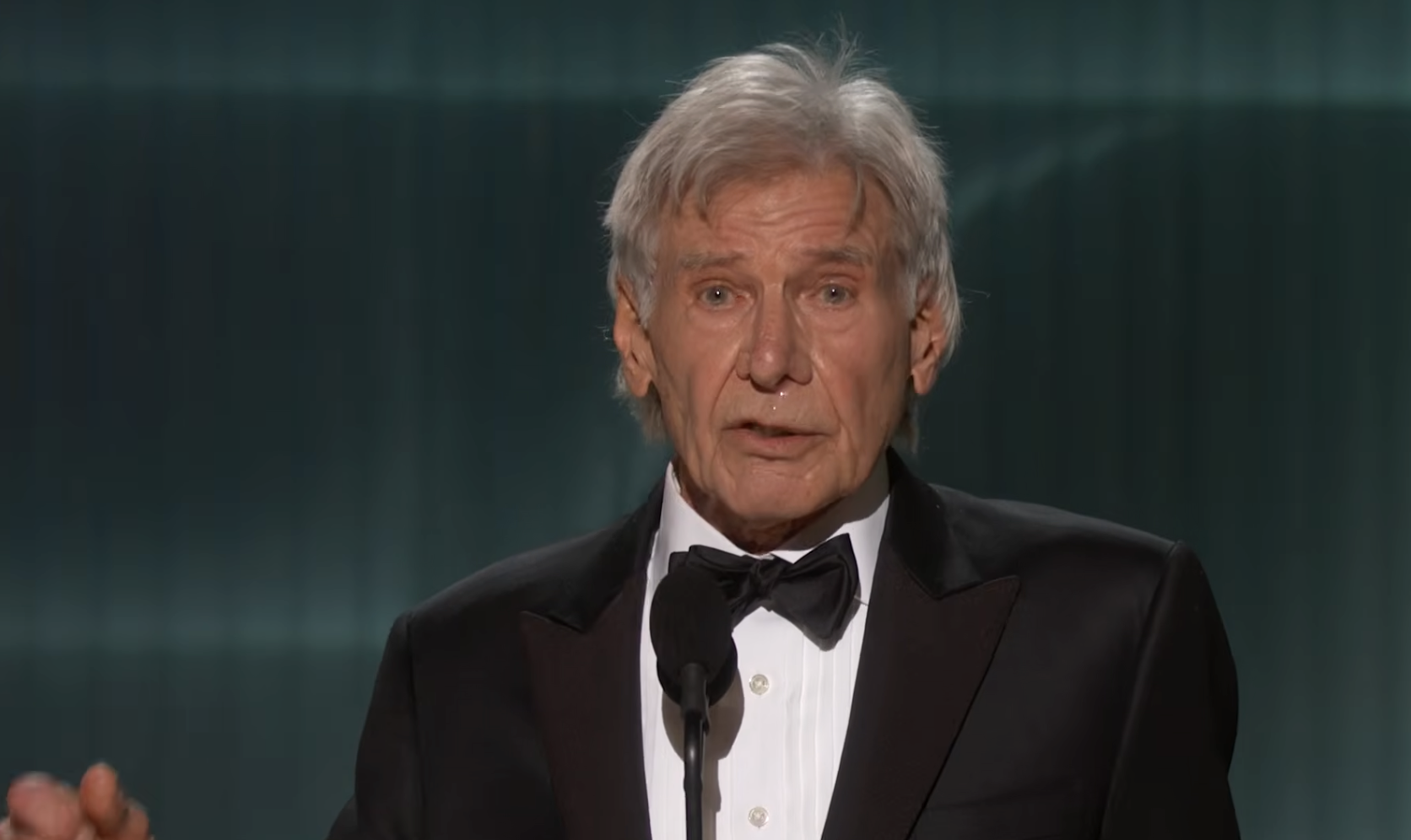 Harrison Ford becomes emotional as he continues to give his speech at the event. | Source: YouTube/Netflix