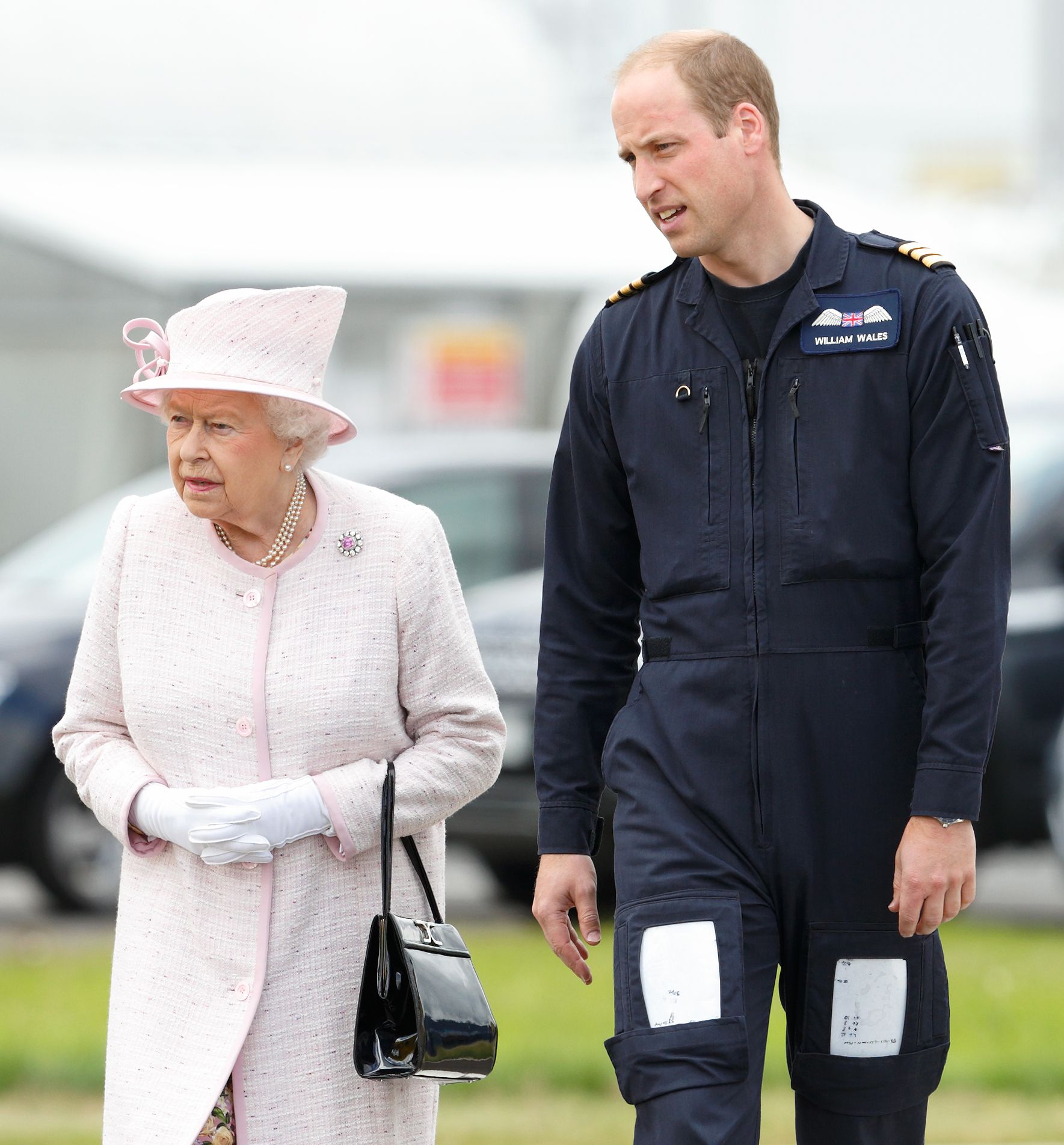 Prince William and Queen Elizabeth II take a tour of the new East Anglian Air Ambulance base at Cambridge Airport on July 13, 2016. | Photo: Getty Images.