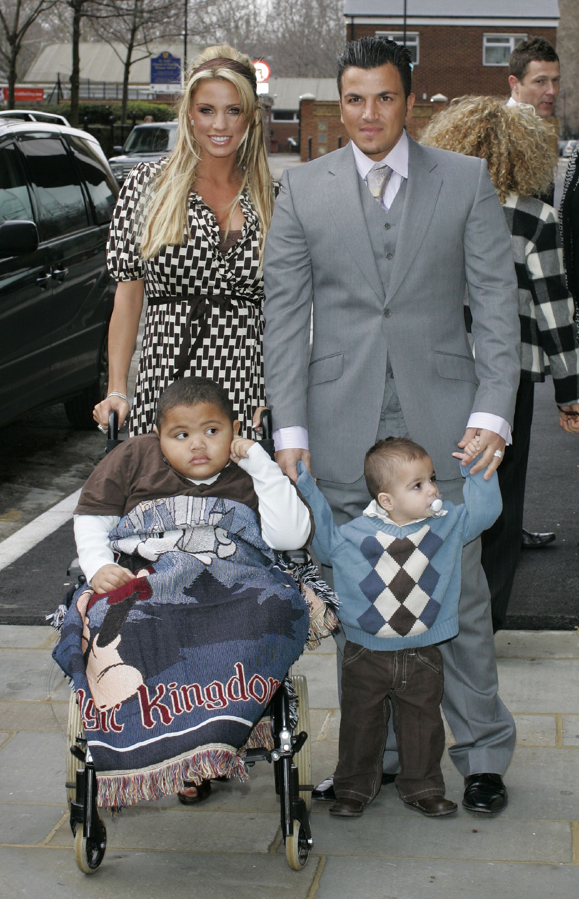 Katie Price and Peter Andre attend the opening of a new Children's Eye Centre at Moorfields Eye Hospital in London on February 23, 2007, accompanied by their sons, Harvey Price and Junior Andre. Wrapped in a "Magic Kingdom" blanket and seated in a wheelchair, Harvey appeared quietly observant, while Junior clutched his father’s hands.