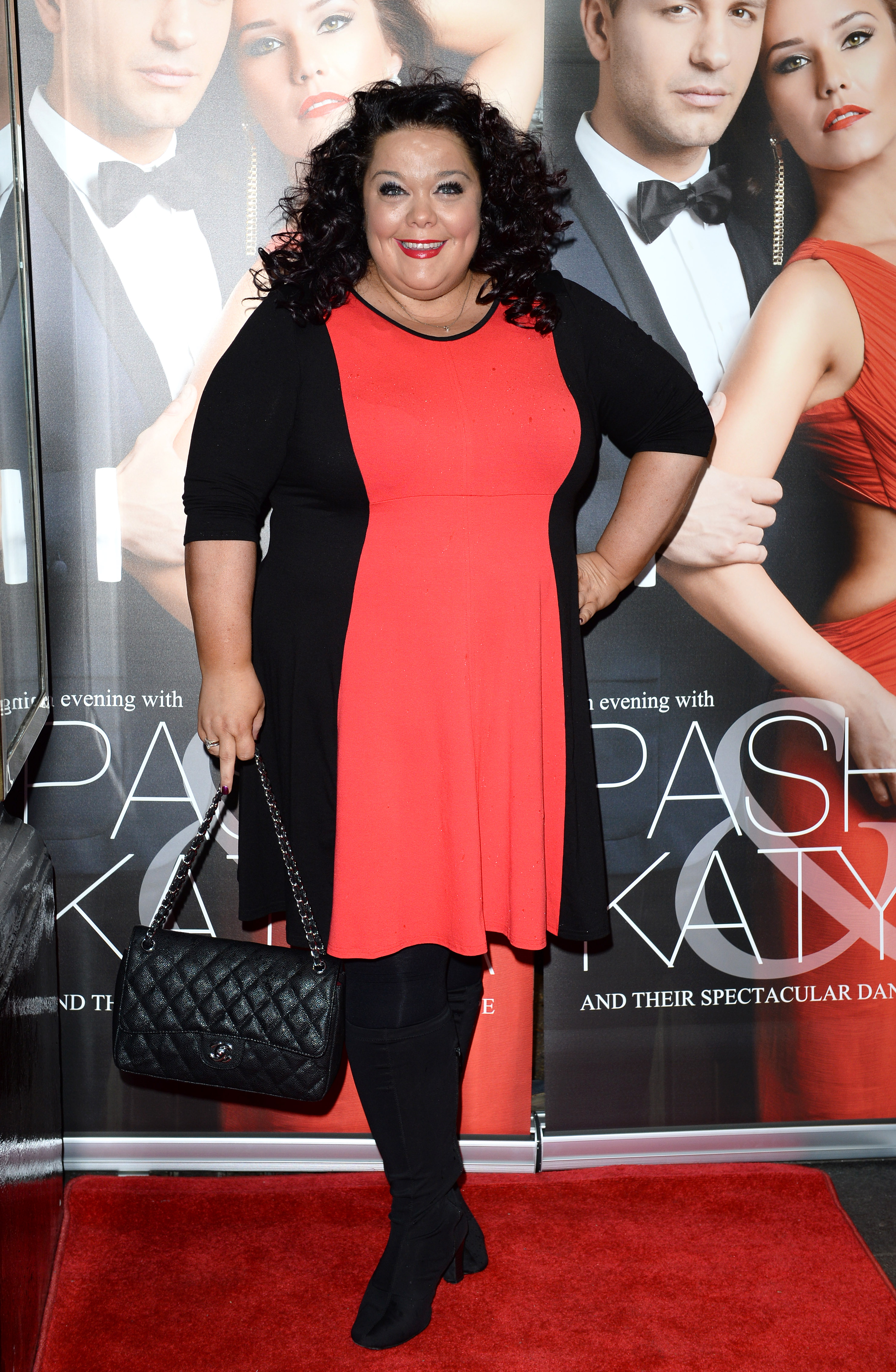 Showstopping in coral! Riley makes a vibrant entrance at the VIP preview of "Katya & Pasha" at London's Lyric Theatre on 7 April 2014, standing out in a bold coral-and-black dress and classic quilted handbag.