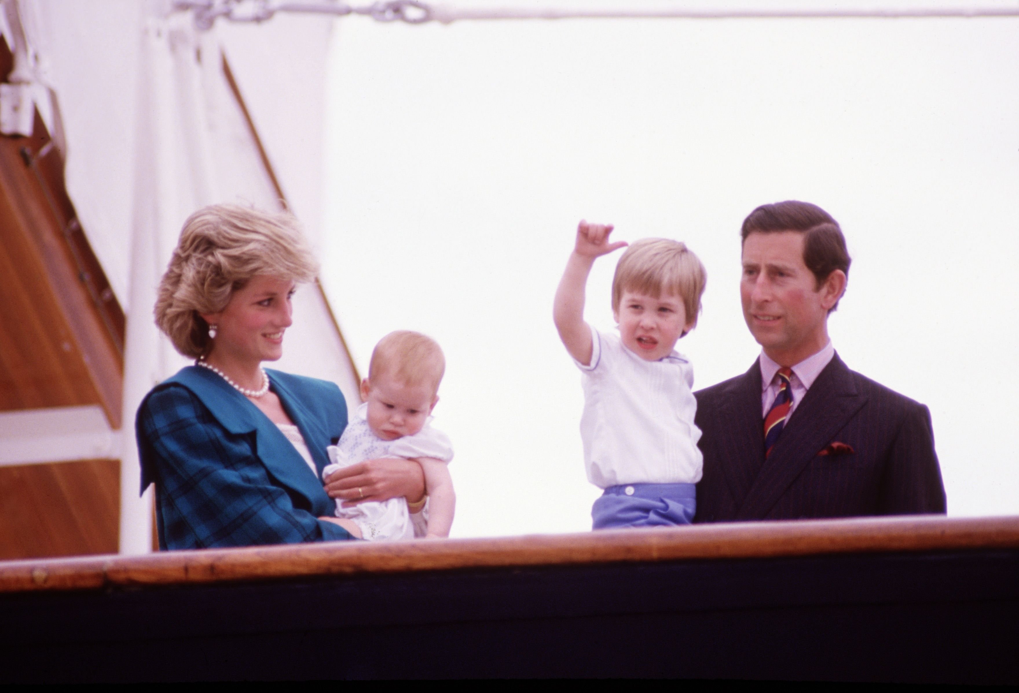Princess Diana and Prince Charles holding sons Prince Harry and Prince William on the deck of the Royal Yacht Britannia, during the Royal Tour of Italy on May 5, 1985, in Venice, Italy | Photo: David Levenson/Getty Images