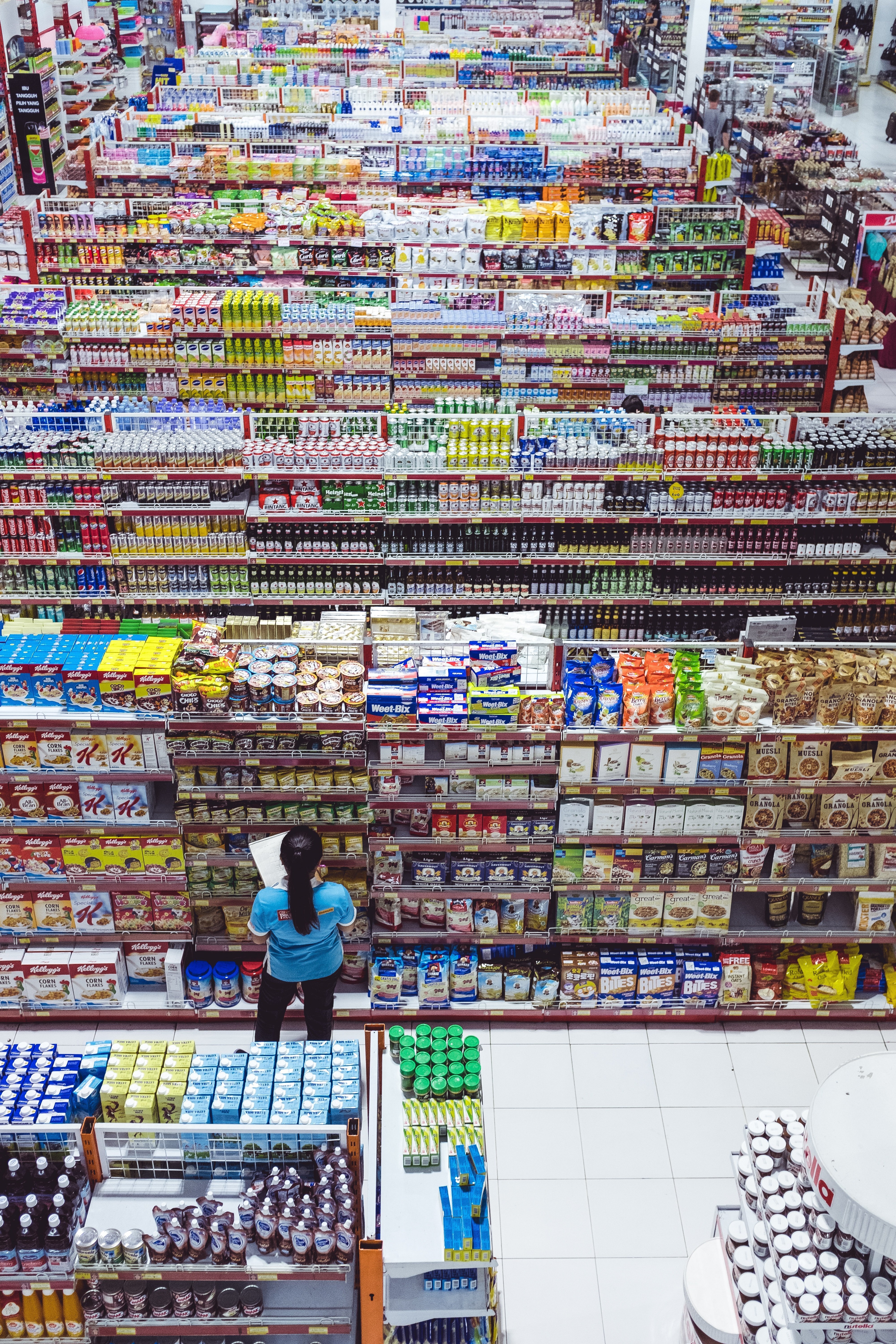 A manager checking the isles of a store | Source: Unsplash.com