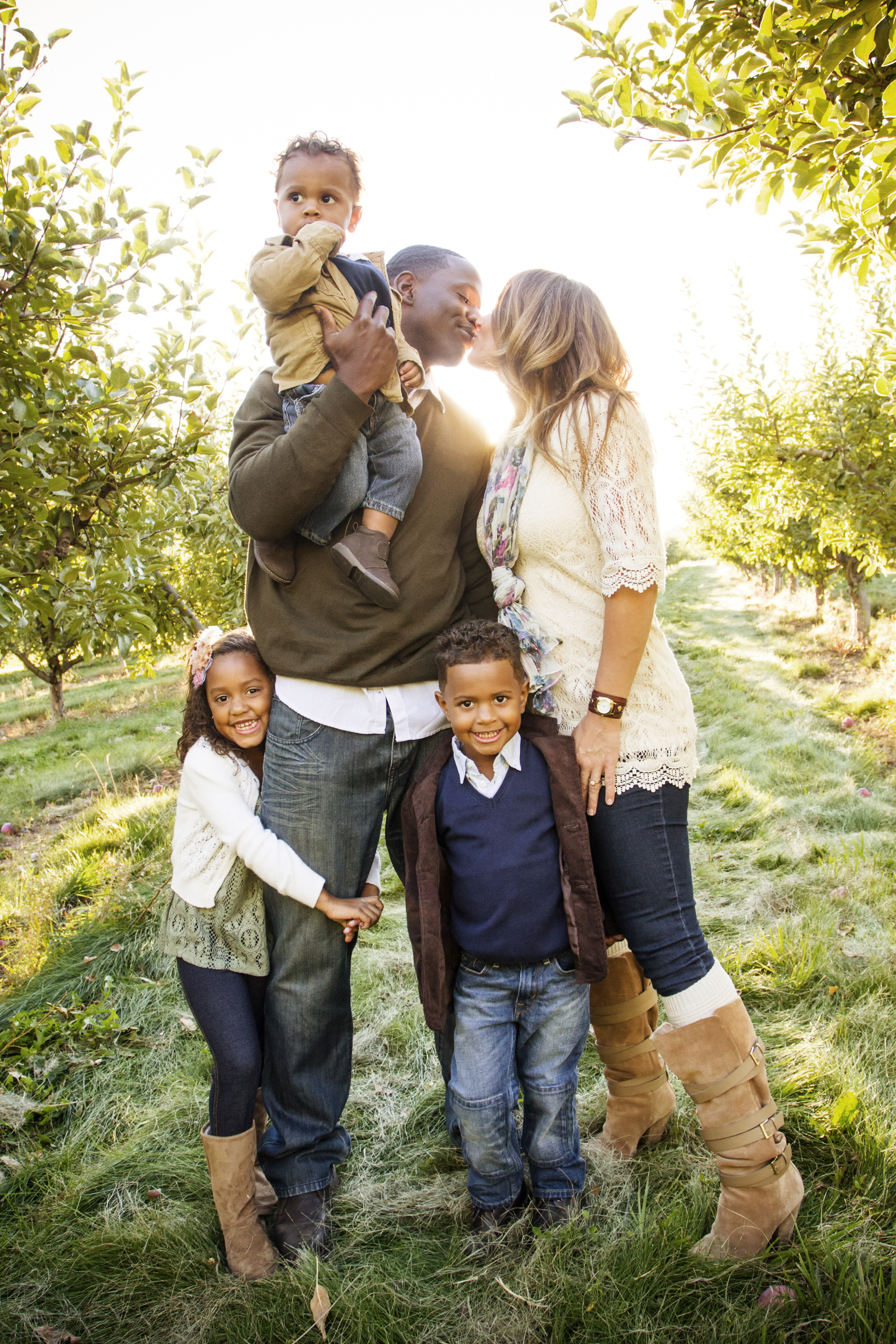 A multi-ethnic family is pictured having a wonderful time outdoors | Source: Shutterstock