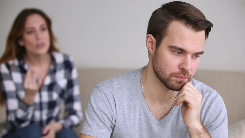 A man and a woman having an argument in their living room | Photo: Shutterstock