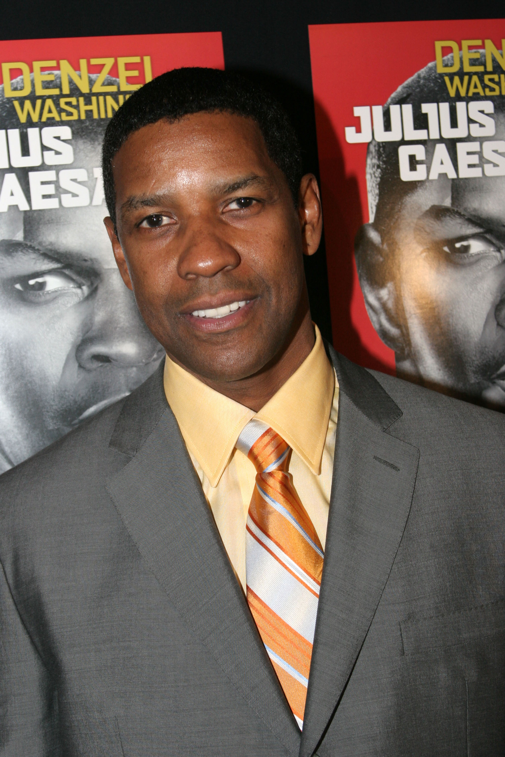 At the opening night party for "Julius Caesar" on Broadway, Denzel Washington sports a clean-cut look and sharply edged fade, paired with a gray suit and striped tie — a modern take for his commanding role in the Shakespearean revival.